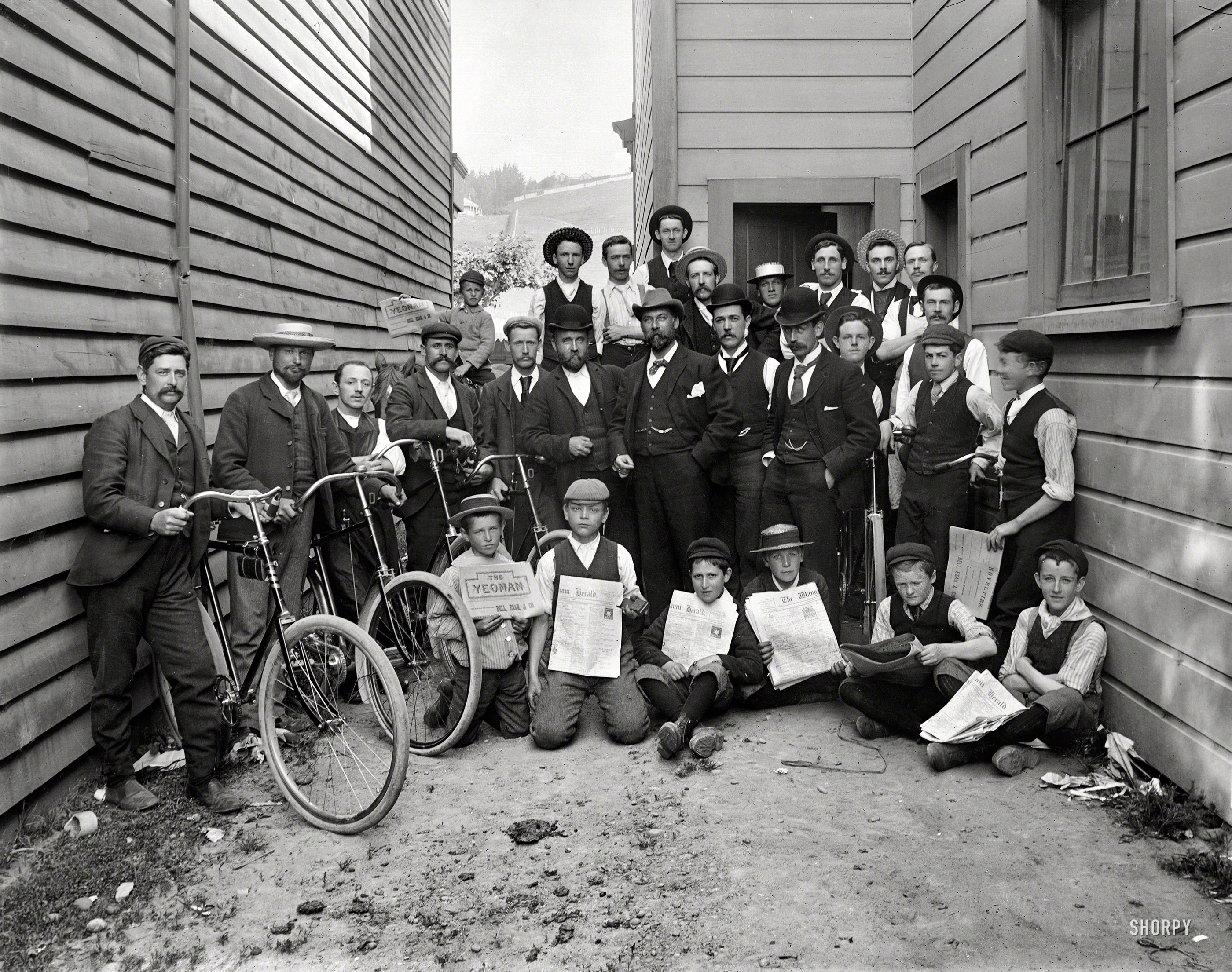 New Zealand, 1907. "Wanganui Herald newspaper staff and bicycles, photograph&shy;ed by Frank J. Denton. Newsboys holding copies of The Yeoman and Herald." Note the kid in back on the horse. Tesla Studios glass negative. View full size.