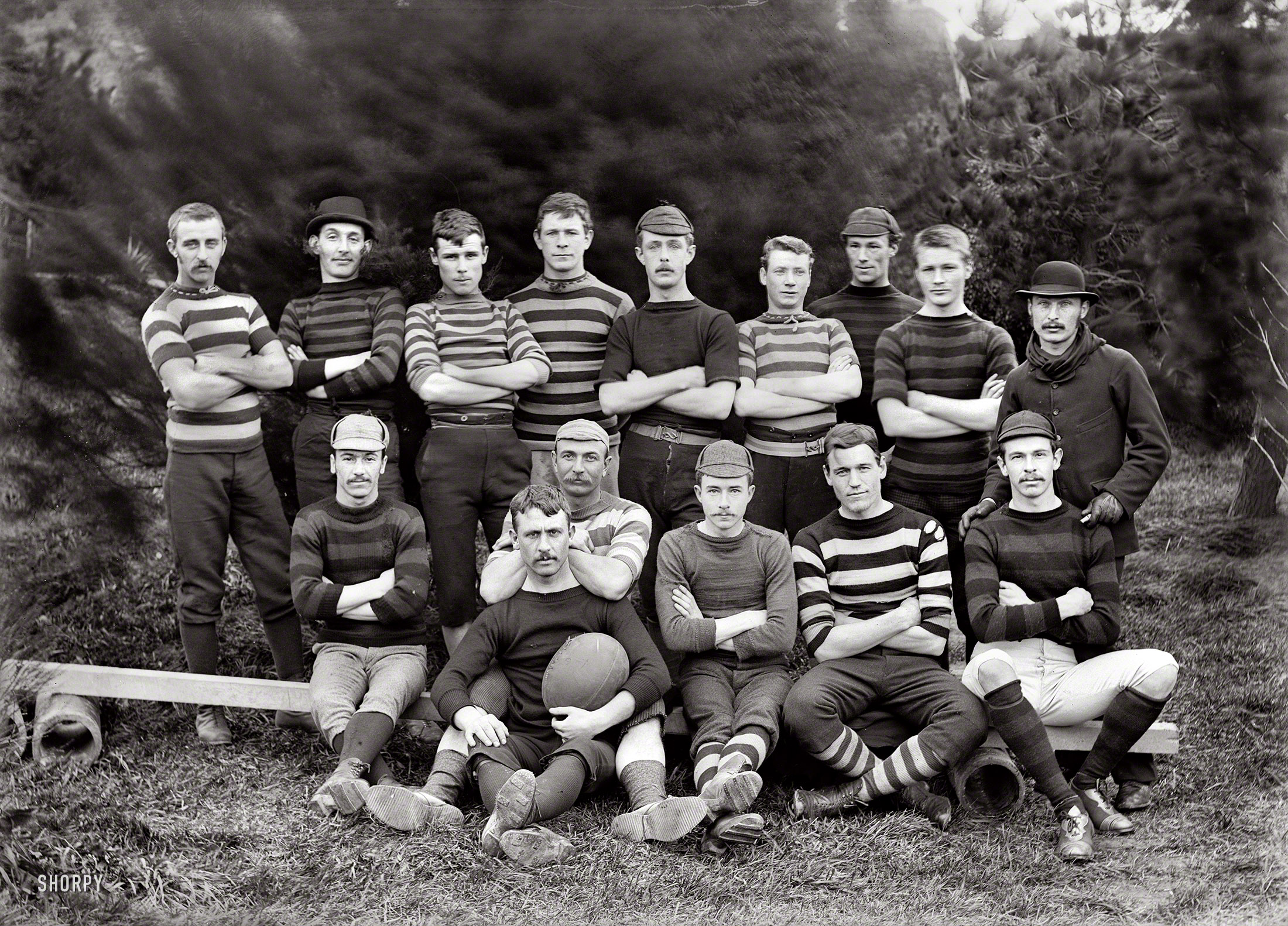 Wellington, New Zealand, 1890. "Post and Telegraph Department football team with men in rugby football kit. Postmaster William Copeland seated behind man with ball." Glass negative by Frederick James Halse. View full size.