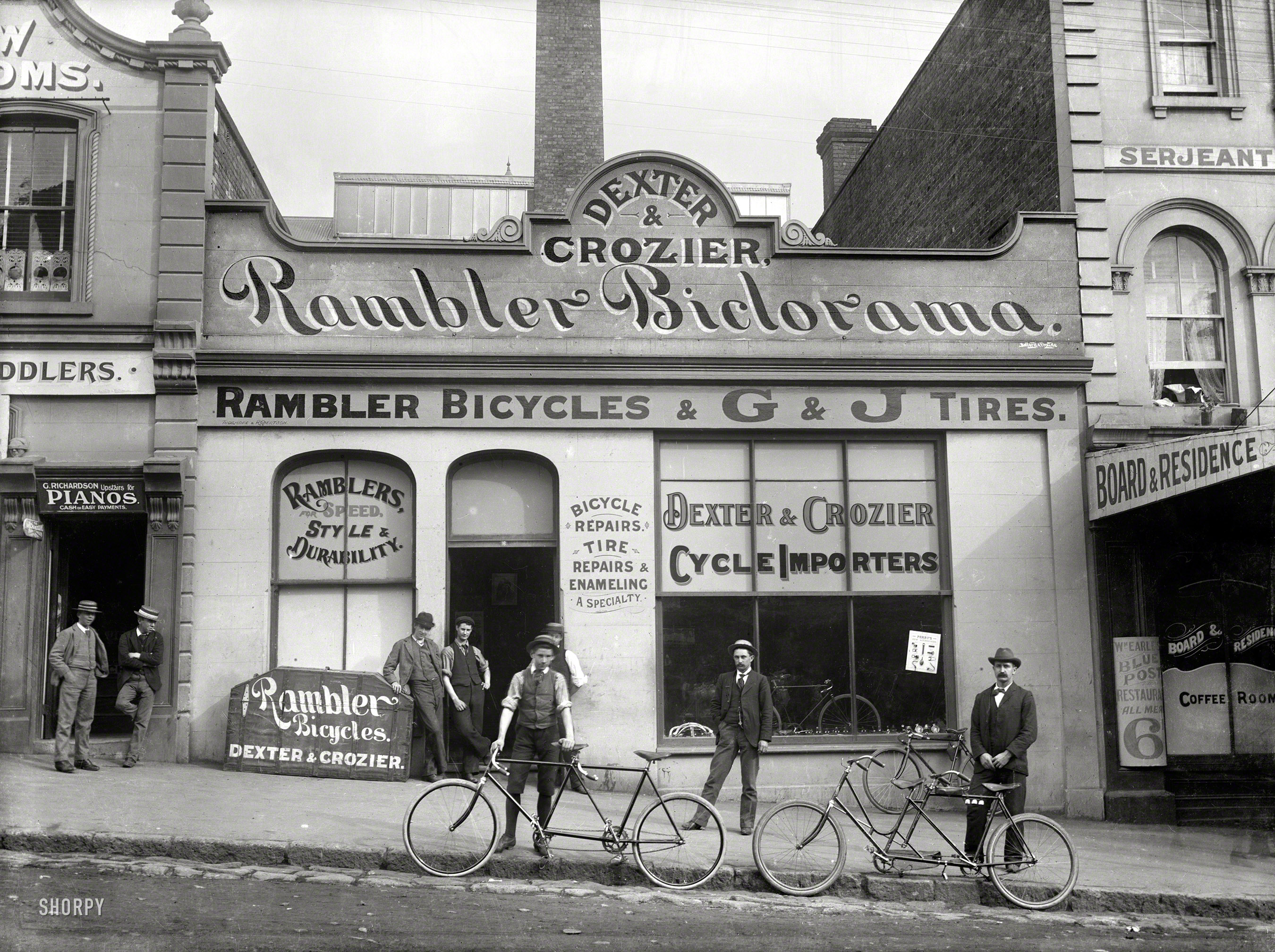 Auckland, New Zealand, 1902. "Dexter & Crozier, cycle importers, Victoria Street East." Glass negative by James Hutchings Kinnear. View full size.