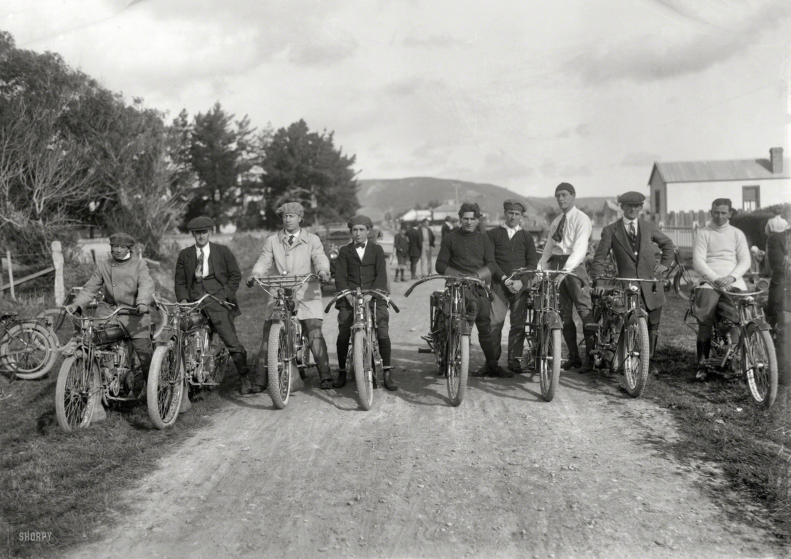New Zealand circa 1920. "Young men on motorcycles, probably Wanganui region." Ready to run some errands, and you'd better not get in the way. Or else they might be late. Tesla Studios glass negative. View full size.