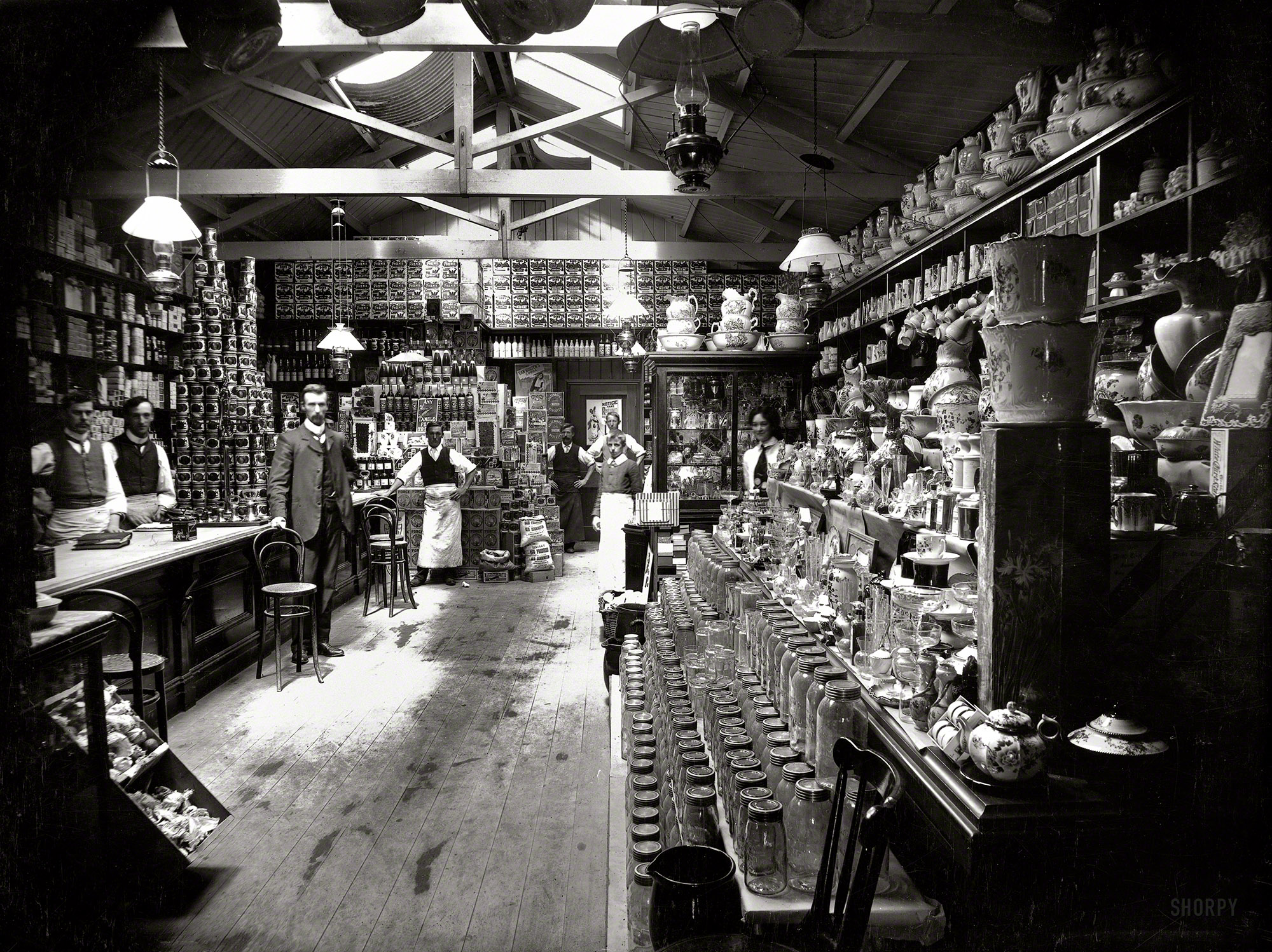 1890s New Zealand. "Grocery shop interior, with staff, location unidentified." Silver gelatin print, photographer unknown. View full size.
