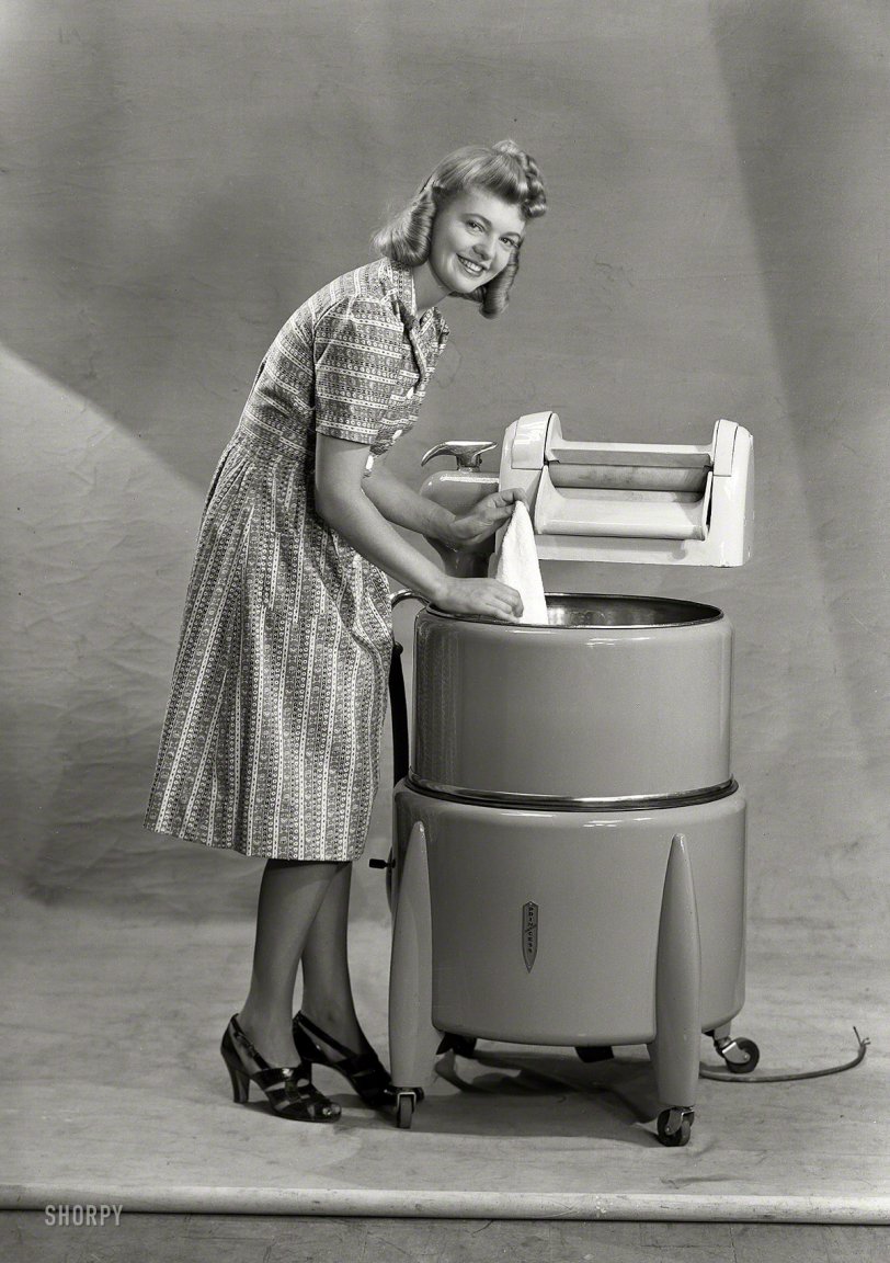 New Zealand circa 1950s. "Model with wringer washing machine." I am Woman, see me Wash. Photo by Gordon Burt Studio. View full size.
