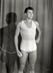New Zealand circa 1958. "Men's underwear being modeled, photographed by K.E. Niven &amp; Co. of Wellington." Alexander Turnbull Library negative. View full size.
The shaver-Wish he was posing holding it somewhere else, say, near his face.
Anatomical detailFor a nation most Americans would assume to be rather staid and proper, New Zealand seems -- at least as revealed thus far on Shorpy -- to be accustomed to presenting rather more detail as to what lies beneath in its photos for underwear ads.  Supposing this photo to be for a catalogue, one wonders if some judicious retouching might be expected en route to the final product.
Waist lineUp to rib cage, really?
Philips/Norelco 7748The type shown is a Philishave "two-head-egg-type" 7748, in the U.S. sold as the Norelco Electric Shaver 7748, the "Norelco Doubleheader". I suppose in New Zealand they were sold under the name Philips/Norelco.
(The Gallery, Bizarre, New Zealand)