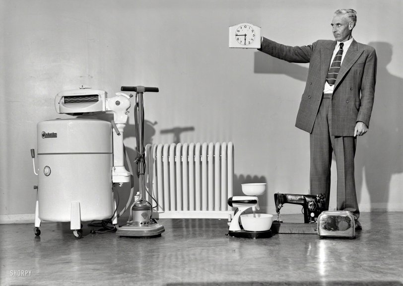 Wellington, New Zealand, circa 1950. "Household appliances including washing &amp; sewing machine, mixer, toaster, polisher and heater." Also a control-robot with three hands -- hour, minute and left. Photo by K.E. Niven &amp; Co. View full size.
