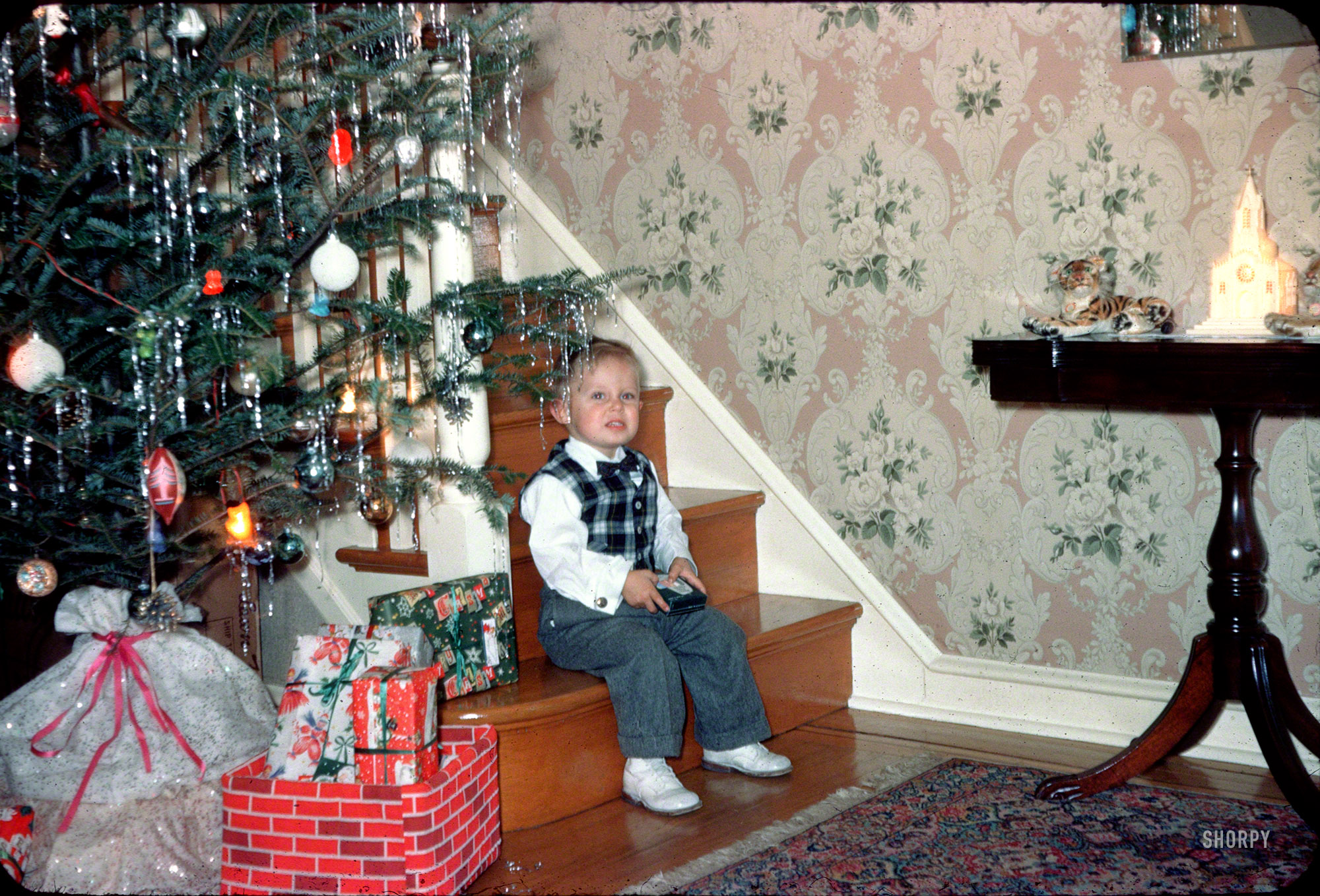 Christmas 1958 somewhere in Pennsylvania. The young man we last glimpsed dressed up for Halloween, seen here in our fifth slide from a batch of 35mm Kodachromes found on eBay. I am imagining carols on the hi-fi, grandparents in the next room and delicious aromas wafting in from the kitchen. View full size.