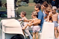 August 1961. Summer in Hyannis Port: "President John F. Kennedy driving a golf cart full of Kennedy [Shriver, Smith, Lawford] family children." Photo by Stanley Tretick for the Look magazine assignment "Uncle Jack." View full size.