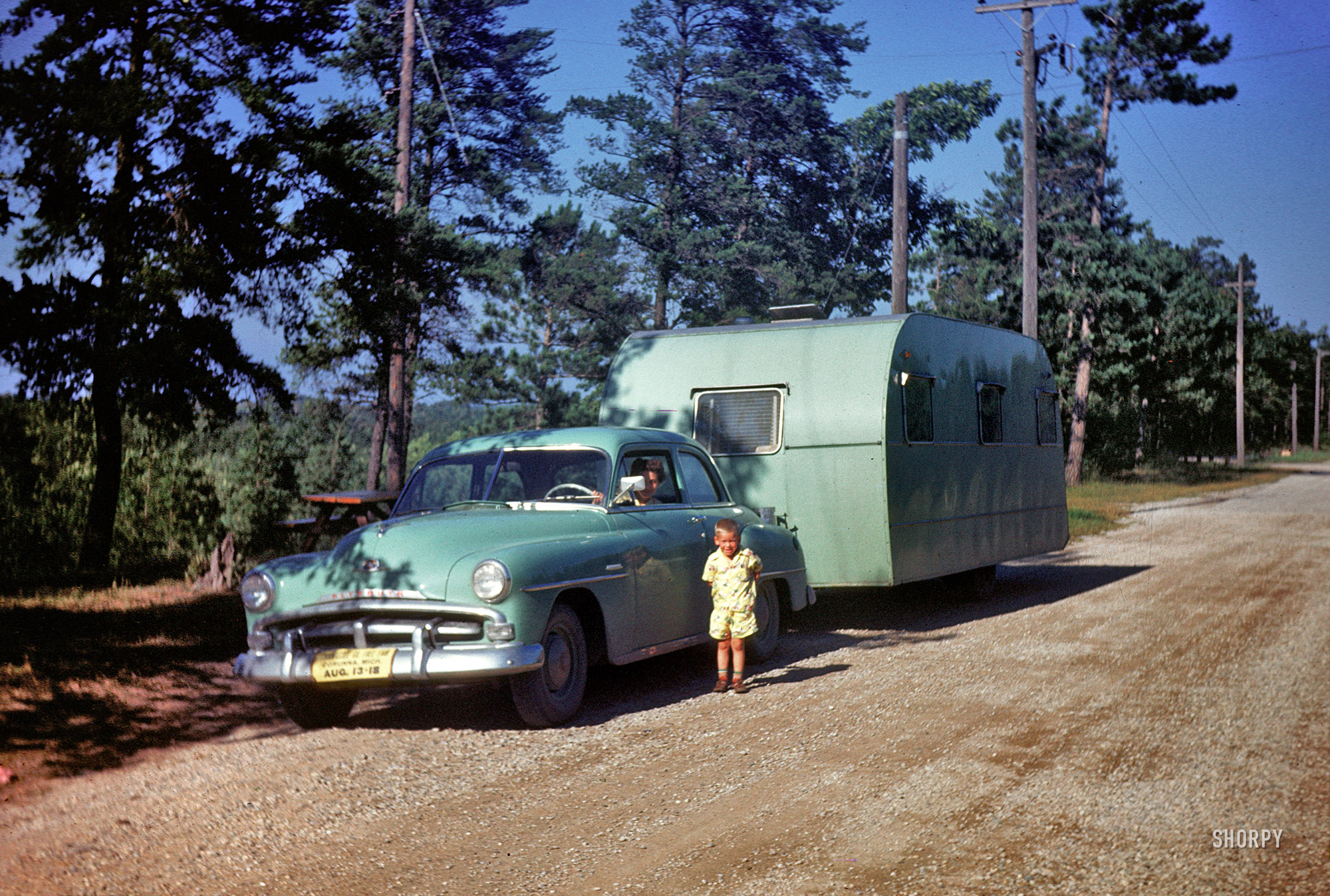"Burt Lake, 1951." Our young man with color-coordinated Plymouth and travel trailer, and Mama at the wheel. 35mm Kodachrome slide. View full size.