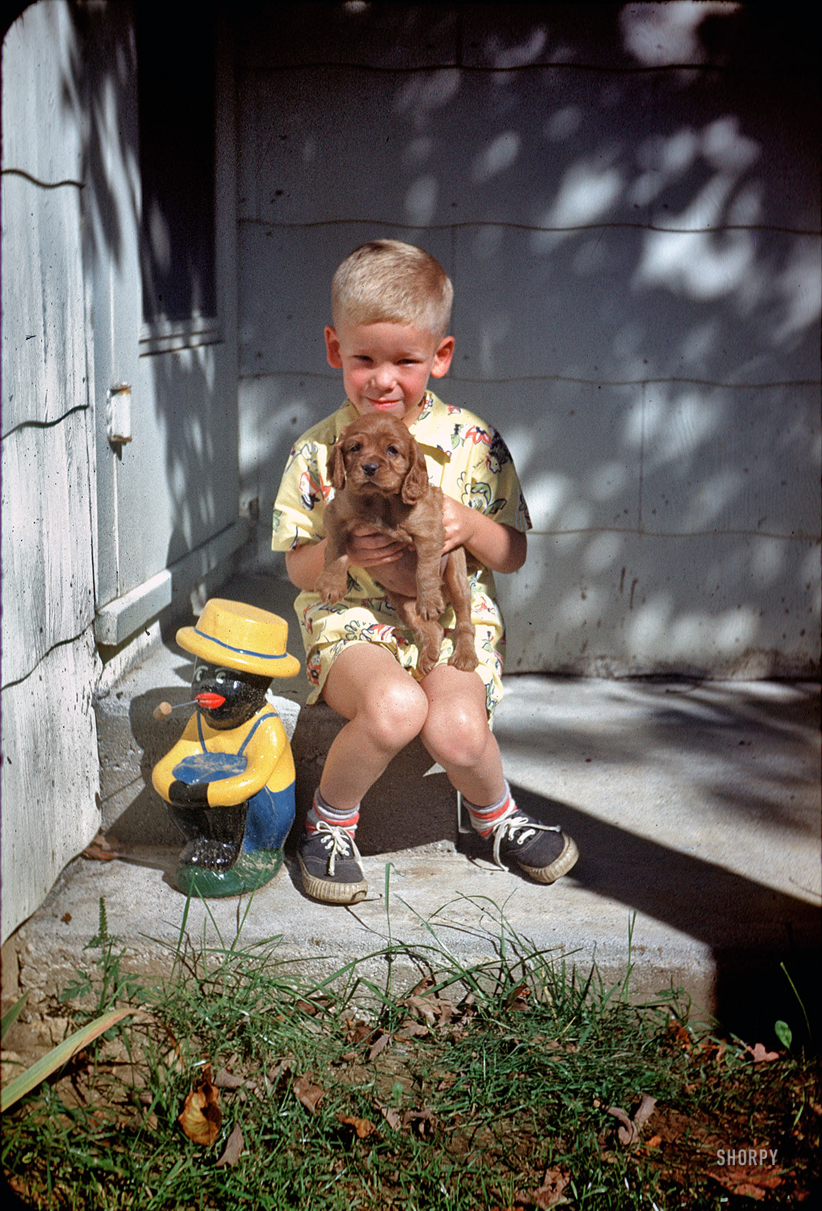 "1951." The boy and his dog, along with a radioactive lawn ornament. From a box of 35mm Kodachrome slides found last month on eBay. View full size.