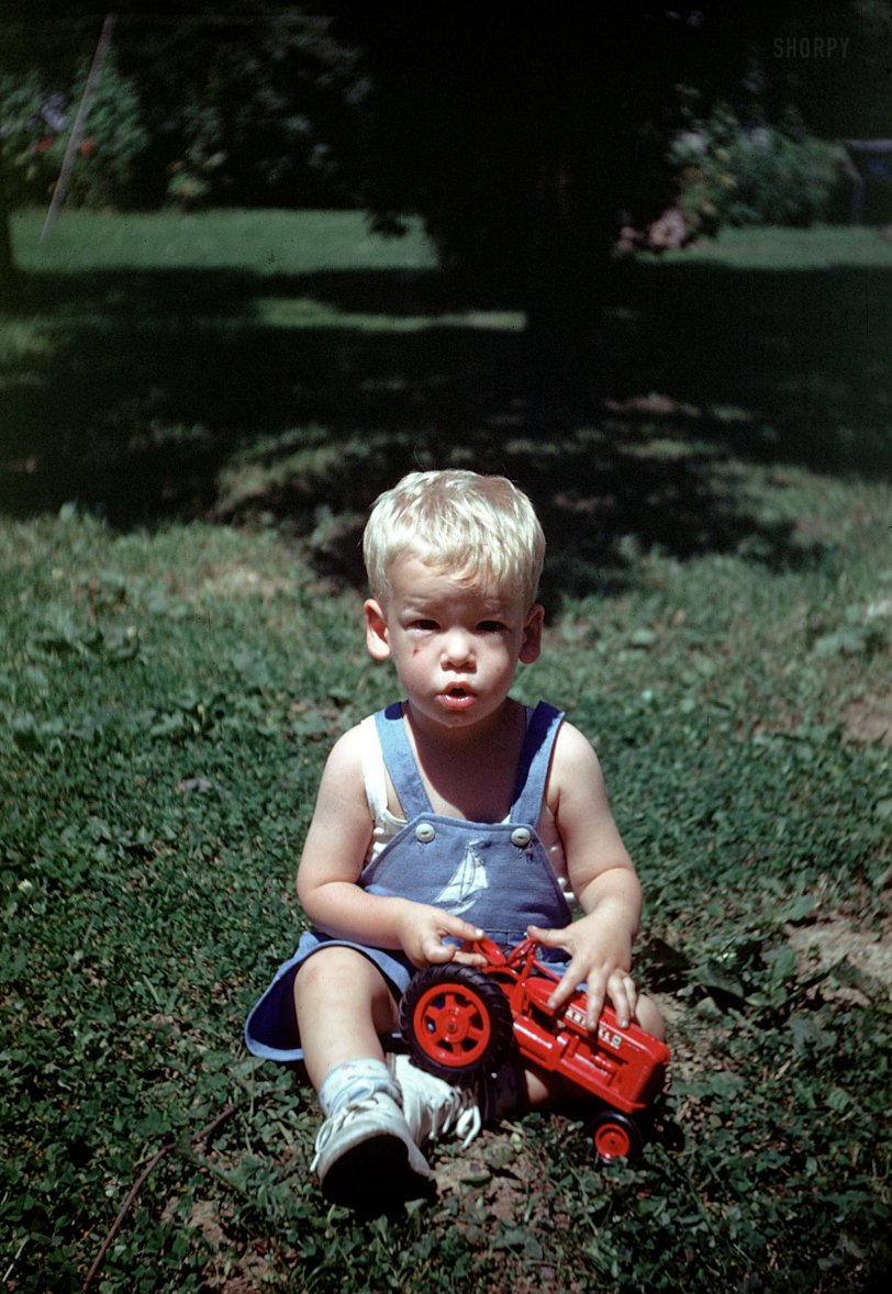 "1948." Our young man explores his agricultural inclinations with a Farmall tractor. 35mm Kodachrome slide found on eBay. View full size.
