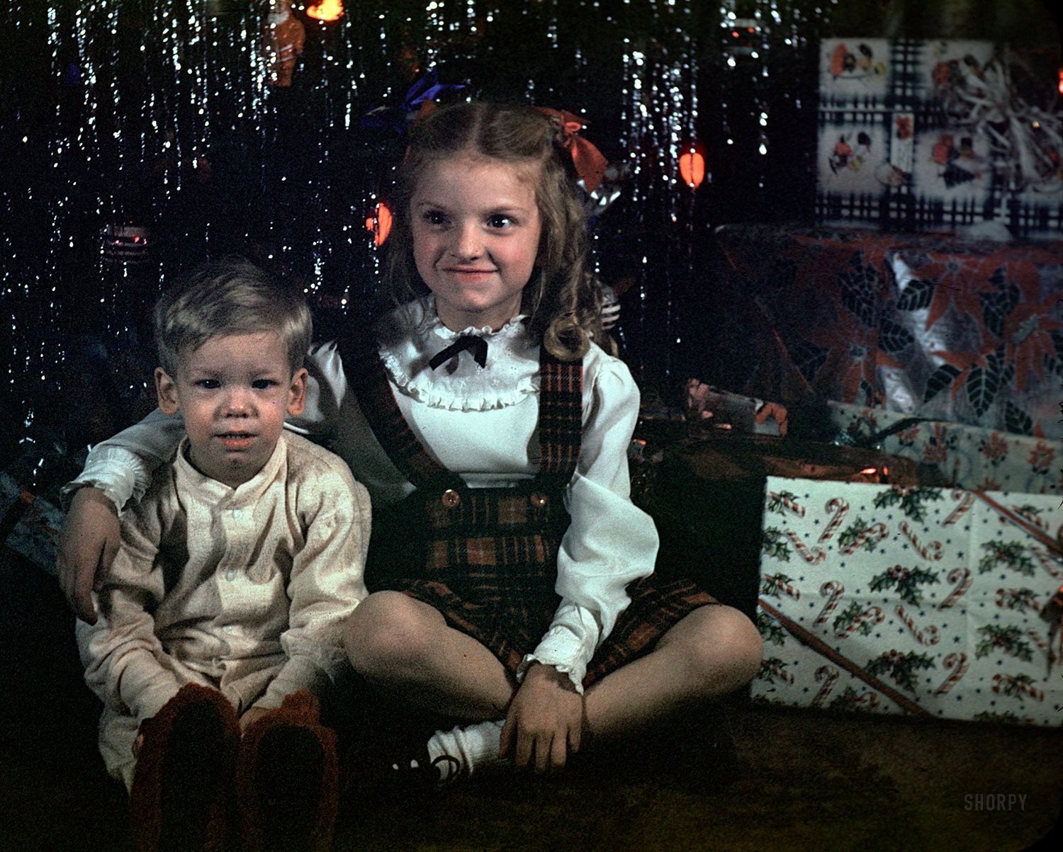  "Xmas 1948," featuring the young man we've come to know so well, kicks off our Kodachrome Christmas weekend!  We're inclined to say these two are cousins rather than sibs, based on the relatively few appearances the girl makes in the dozens of slides in this batch, taken in Bay County, Michigan. View full size.