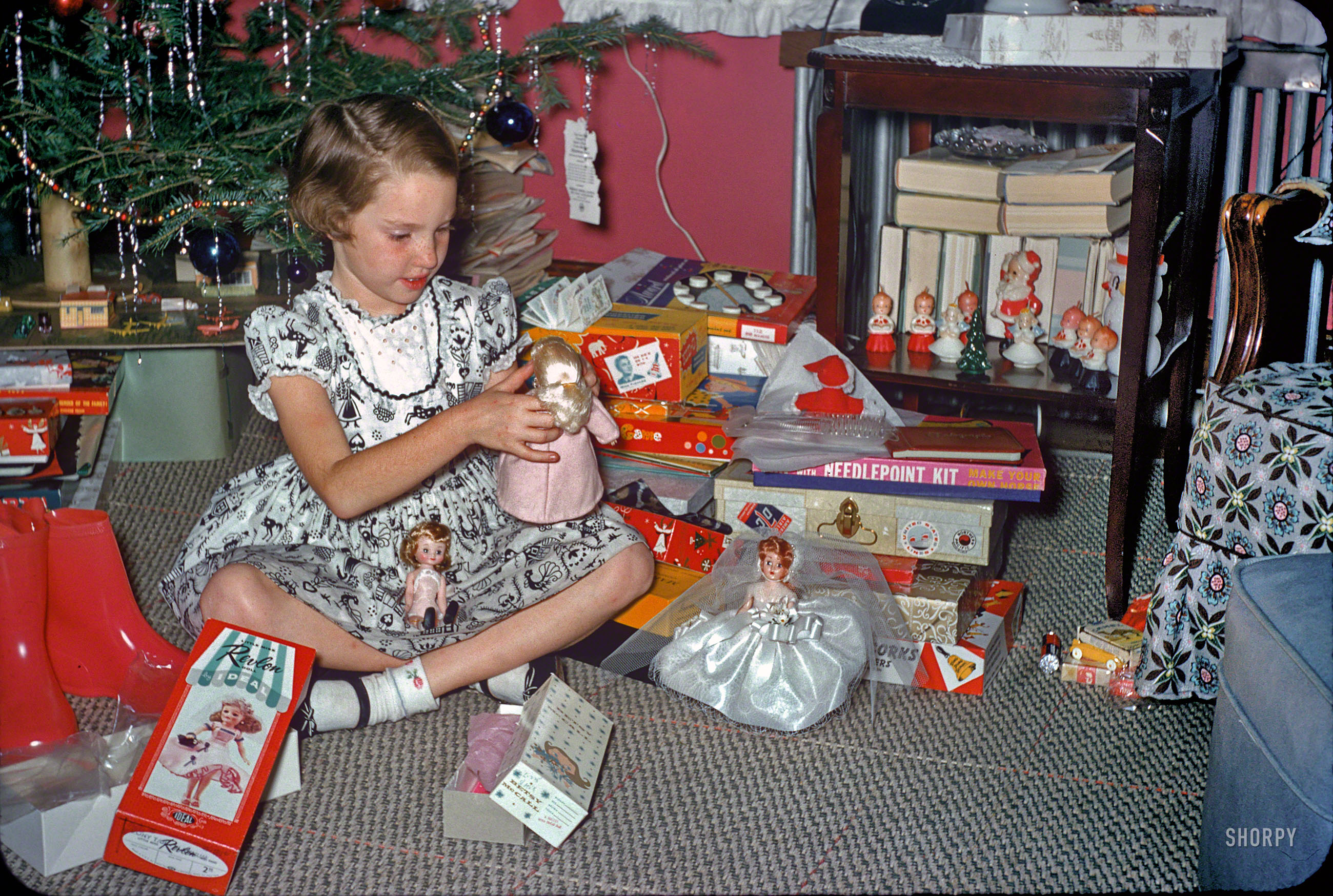"Christmas 1957." Having seen the boy toys at Kermy and Janet's house in Baltimore, we now move on to the girl gifts, which include Little Miss Revlon and Betsy McCall dolls as well as a Fun With Needlepoint Kit ("Make your own horse"). What else do we recognize here? 35mm Kodachrome slide. View full size.
