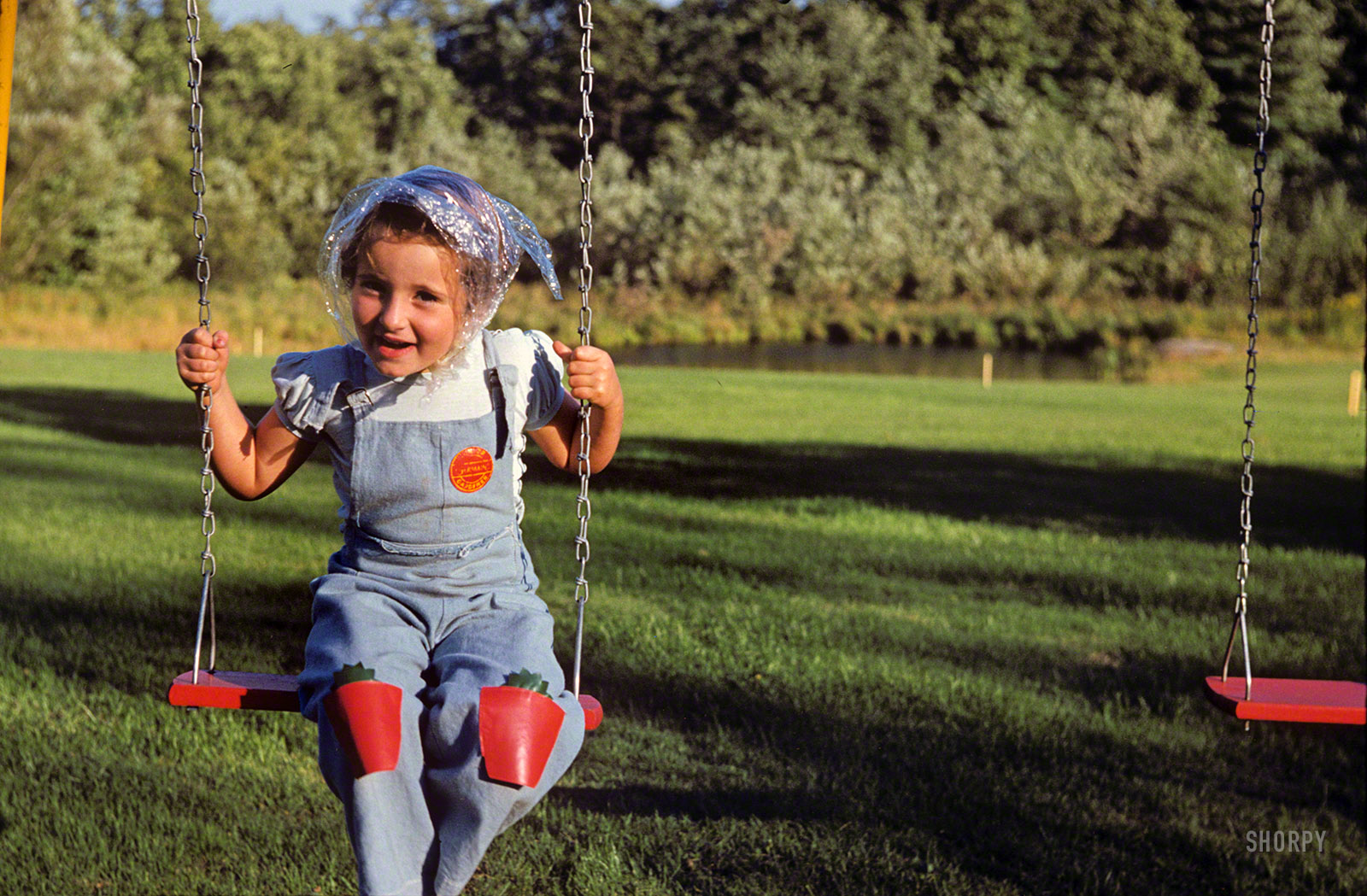 "Linda 1952." The little lady returns in her "Junior Gardener" overalls, now with stylish futuristic headgear. 35mm Kodachrome. View full size.