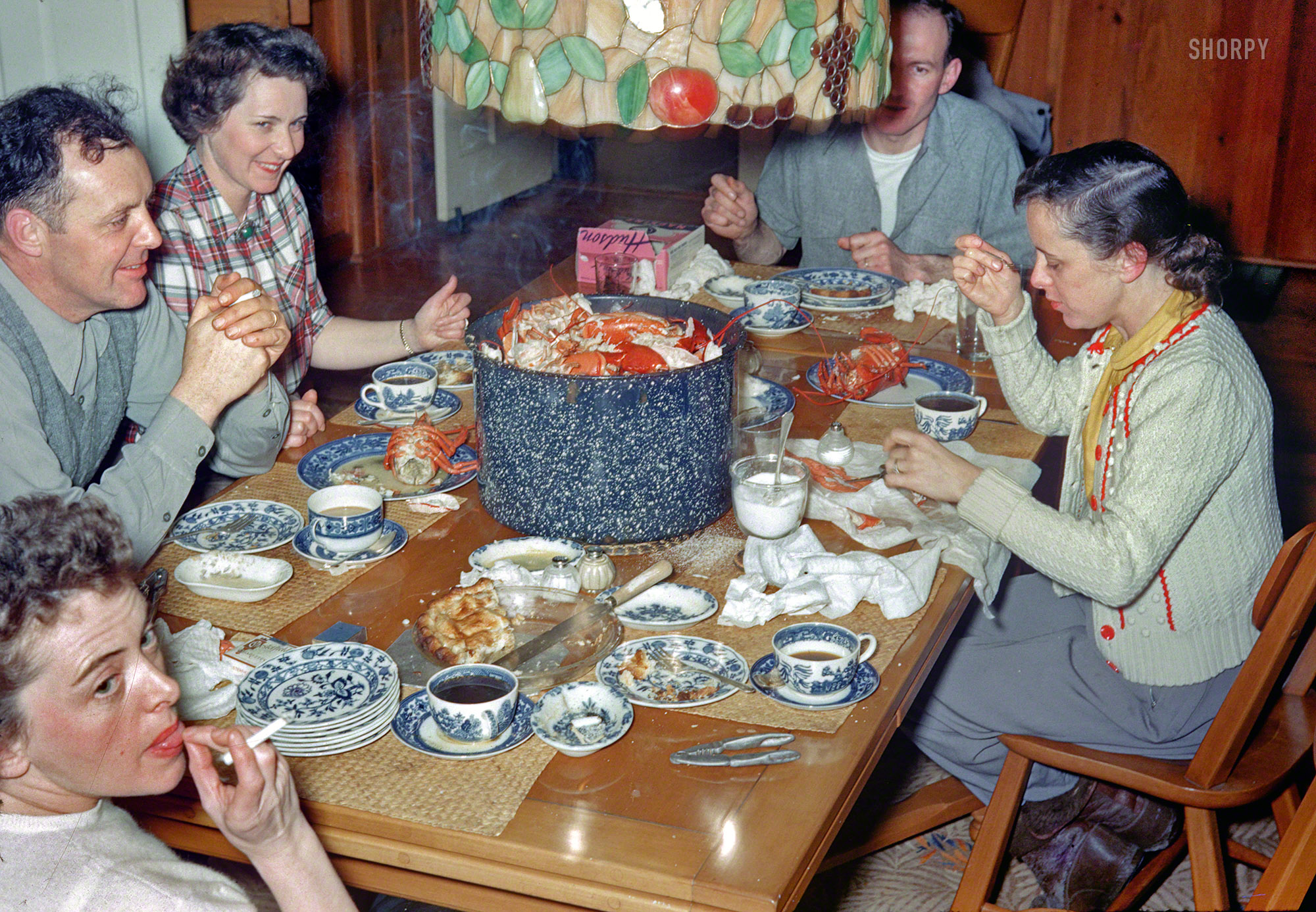 Circa 1955 somewhere in New England comes this unlabeled slide from the Linda Kodachromes and its table of boiled lobster and smoking people. View full size.