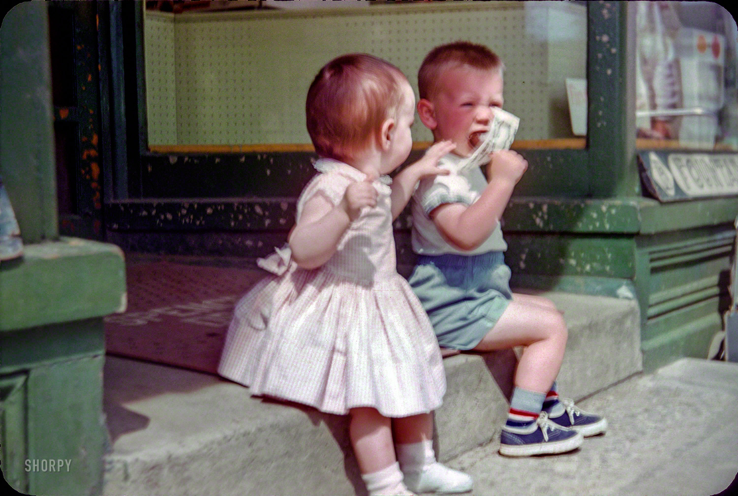 "Wait a minute, Bubba, I think you're doing that wrong." Circa 1948 somewhere in New England, it's little Linda and friend at the drugstore. 35mm Kodachrome slide found on eBay, resuscitated with NikonScan and Photoshop. View full size.