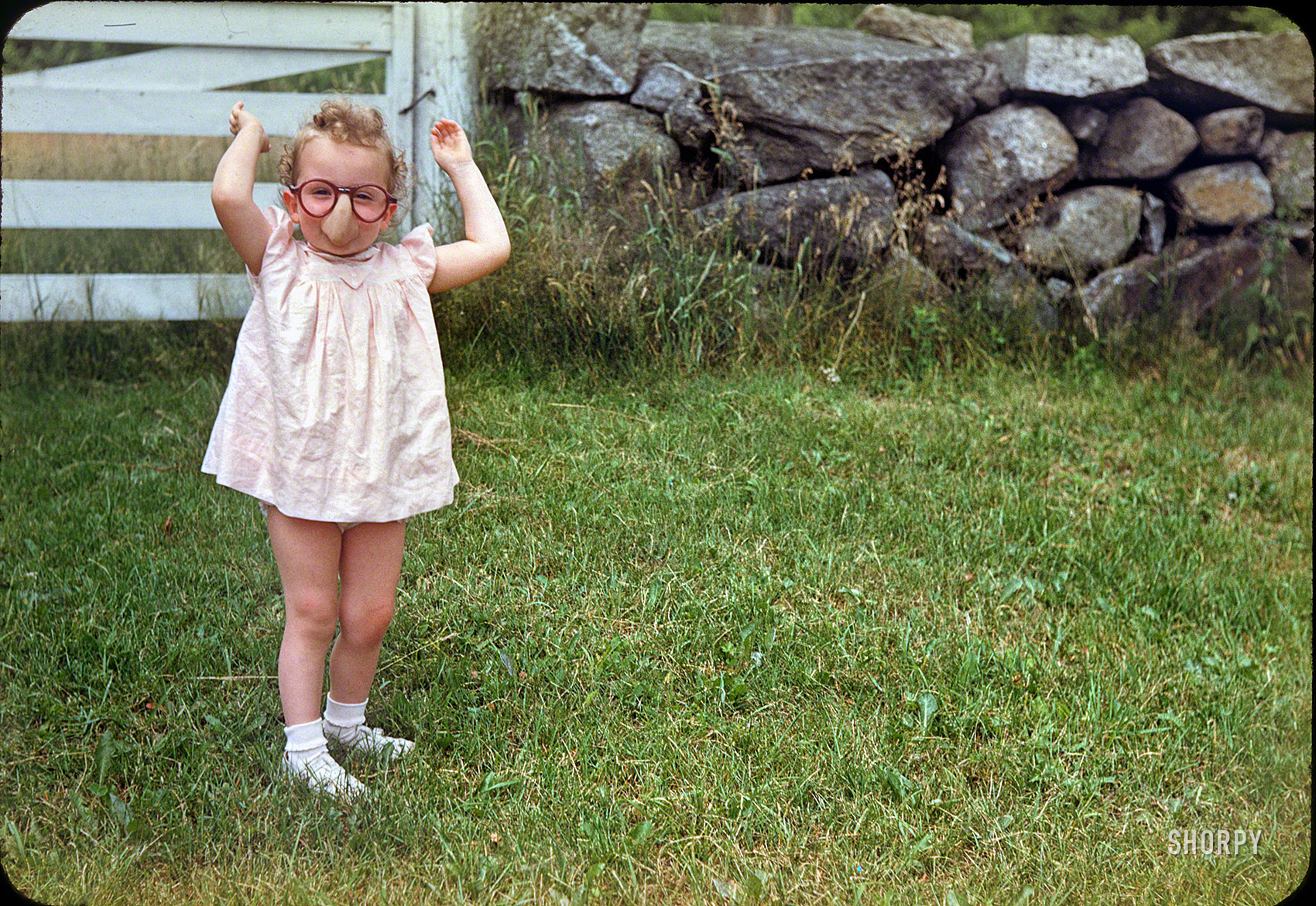 Circa 1949. Little Linda, noted for what some perceive as a taciturn demeanor, shows us what a laff riot she really is. 35mm Kodachrome. View full size.