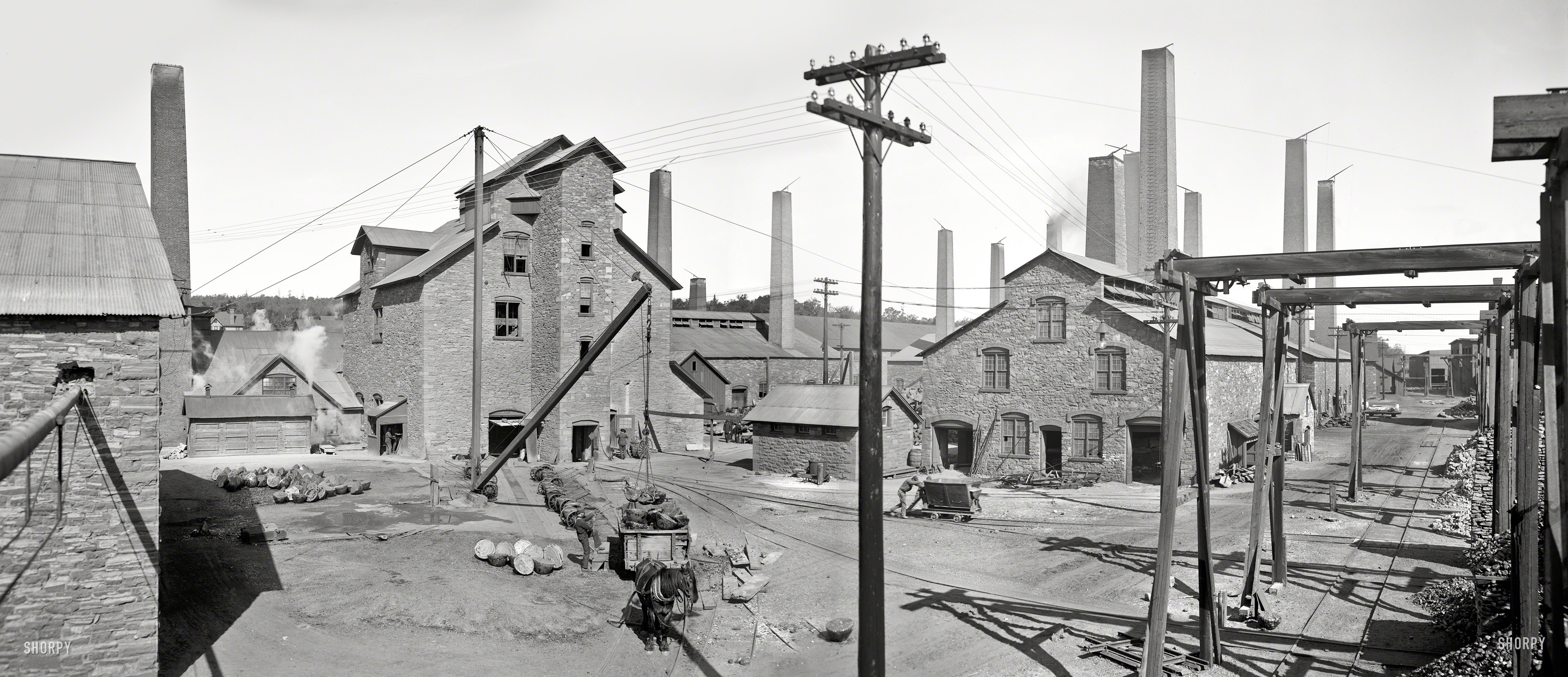 Circa 1905. "Calumet and Hecla smelters, Lake Linden, Michigan." Starting point for the web of copper telephone and streetcar wires seen in so many of the other Detroit Publishing images. Panorama of two 8x10 glass plates. View full size.
