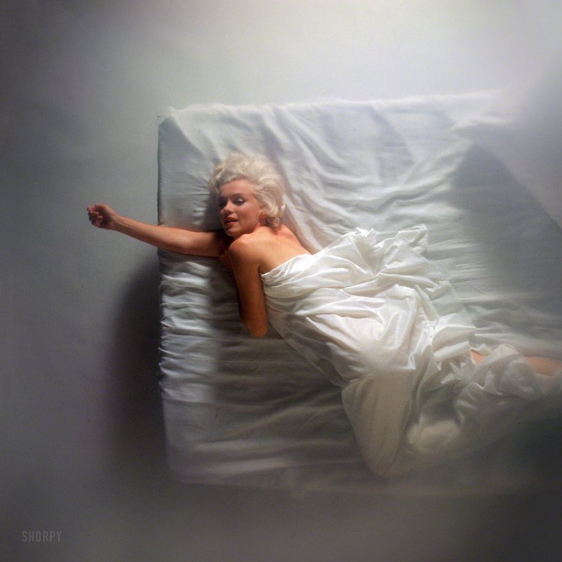1961. "Marilyn Monroe posed on a bed under white sheets." Photo by Douglas Kirkland for the Look magazine assignment "Four for Posterity." View full size.
