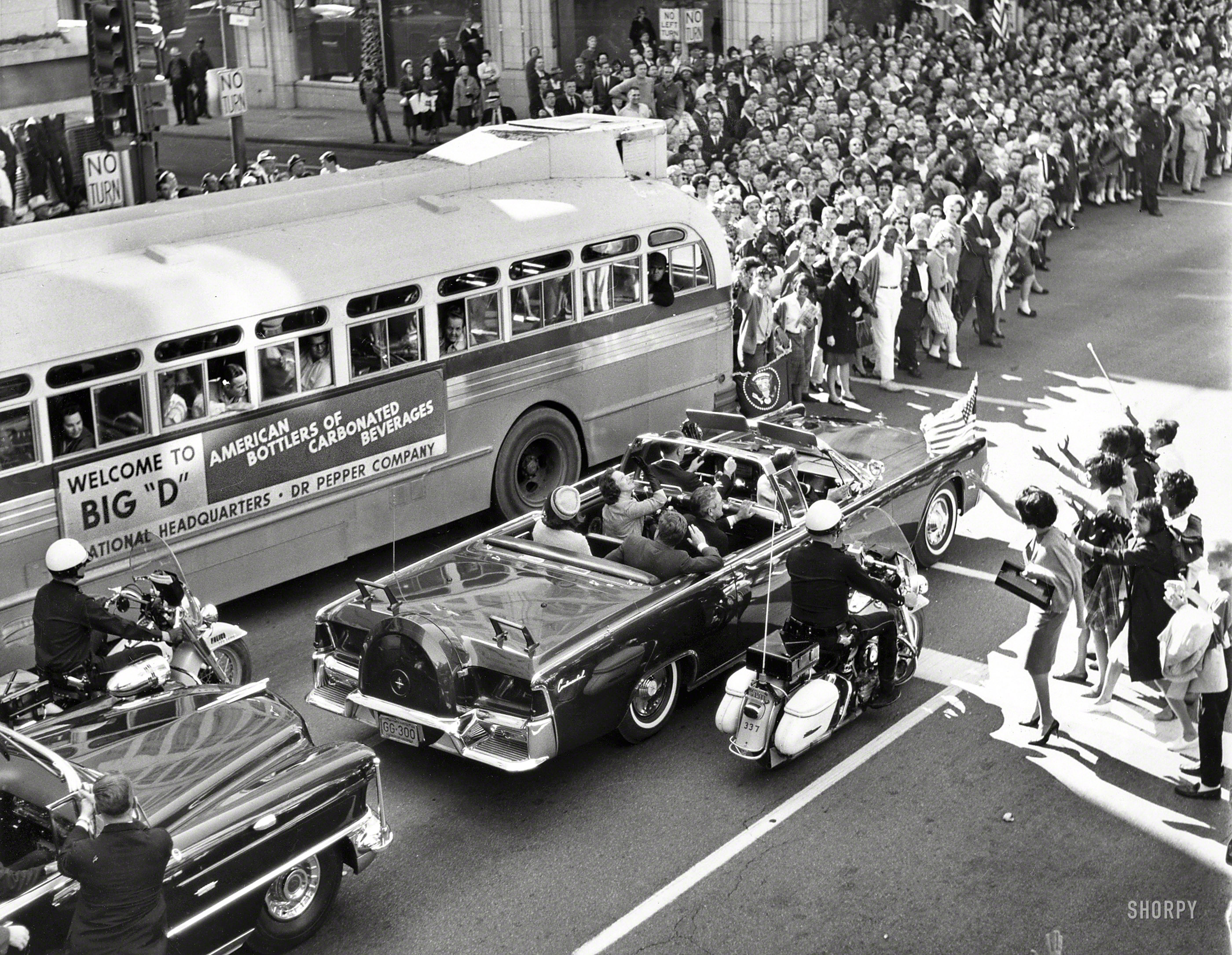 &nbsp; &nbsp; &nbsp; &nbsp; President Kennedy on that dark yet sunny day in Dallas 50 years ago, minutes before he was assassinated.
November 22, 1963. "Overview of crowds of people waving as President John F. Kennedy and his wife sit in back of limousine during procession through downtown Dallas, Texas; Texas Governor John Connally and his wife ride in the limousine's jump seats." New York World-Telegram and the Sun Newspaper Photograph Collection, Library of Congress. View full size.