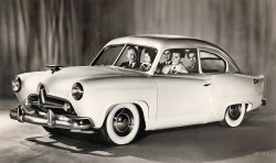 Publicity photo from late 1950 for the Kaiser "Henry J," a small car (named after company chairman Henry J. Kaiser) that was a few years ahead of its time. By 1954, the Henry J had tootled off into oblivion. View full size.
Basic transportation for sureApparently Henry J. Kaiser hoped to become known as the next Henry Ford, or American answer to Adolph Hitler, when he wisely sought to produce a low-priced new car for low-income folks shortly after World War II ended.
But the first models of the Henry J. had no trunk lid, so you'd access that area by folding down the back seat. Also, the rear windows didn't roll down, there was no glove compartment and no arm rests either.
A friend of mine owned a used Henry J in the early 1960s and it was a fun car to buzz around in. But our OSHA and highway safety people wouldn't let Americans even near one if they tried to market them now. They were made and sold for only four years.
Quite possiblythe worst looking automobile in history, and there were plenty to choose from.
Darrin influenceAlthough the Henry J prototype wasn’t a Dutch Darrin design, he did tweak it a bit. The signature ‘Darrin Dip’ at the trailing edge of the door betrays his involvement. As well, he is credited for insisting on the rear fender mini fins.  
AllstateIf you didn't like the bare bones austerity of the Henry J, then beginning in 1952 you could buy a more nicely equipped variant at your local Sears store with the name Allstate in its place.  Most of the Allstates came with trunk lids and glove boxes and also had a higher grade interior.  They could be had with a 134 cubic inch four or 161 cubic inch six, which probably resulted in a nice power to weight ratio for the 2,300 lb. car considering that the almost 600 lb. heavier Studebaker Champion only had eight more cubic inches.  1566 were built in 1952 and only 797 early in 1953 when Sears discontinued the program of selling a car through its stores.  The top priced six was only $100 less than the lowest priced Studebaker, which had four doors and even in the base model Champion seemed like a better buy.  Today the Allstates are far rarer than comparable Henry J's.
Airbrushed photoThis photo was retouched by an artist as can be seen by the white line around the left front bumper guard. See also the outline painted on the rear edge of the fender. This practice was very common in the '50s when photos were used for ads in magazines. This prototype car seems to be missing the top part of the doors.
[That kind of retouching was meant for photos appearing in newspapers, which is how this picture was used. - Dave]
Henry JMy parents bought a Henry J in 1952. It was the worst car they ever owned. You couldn't get it started in the morning at least once a week without fiddling with it for 10 or 15 minutes. I remember my father kicking the door and cursing at it, and my mother getting so upset at him. We had it for about two years. 
Popular for drag racingThey were popular bases for drag racing cars - as were any small, inexpensive cars that could be stuffed with a bigger engine.
(The Gallery, Cars, Trucks, Buses)