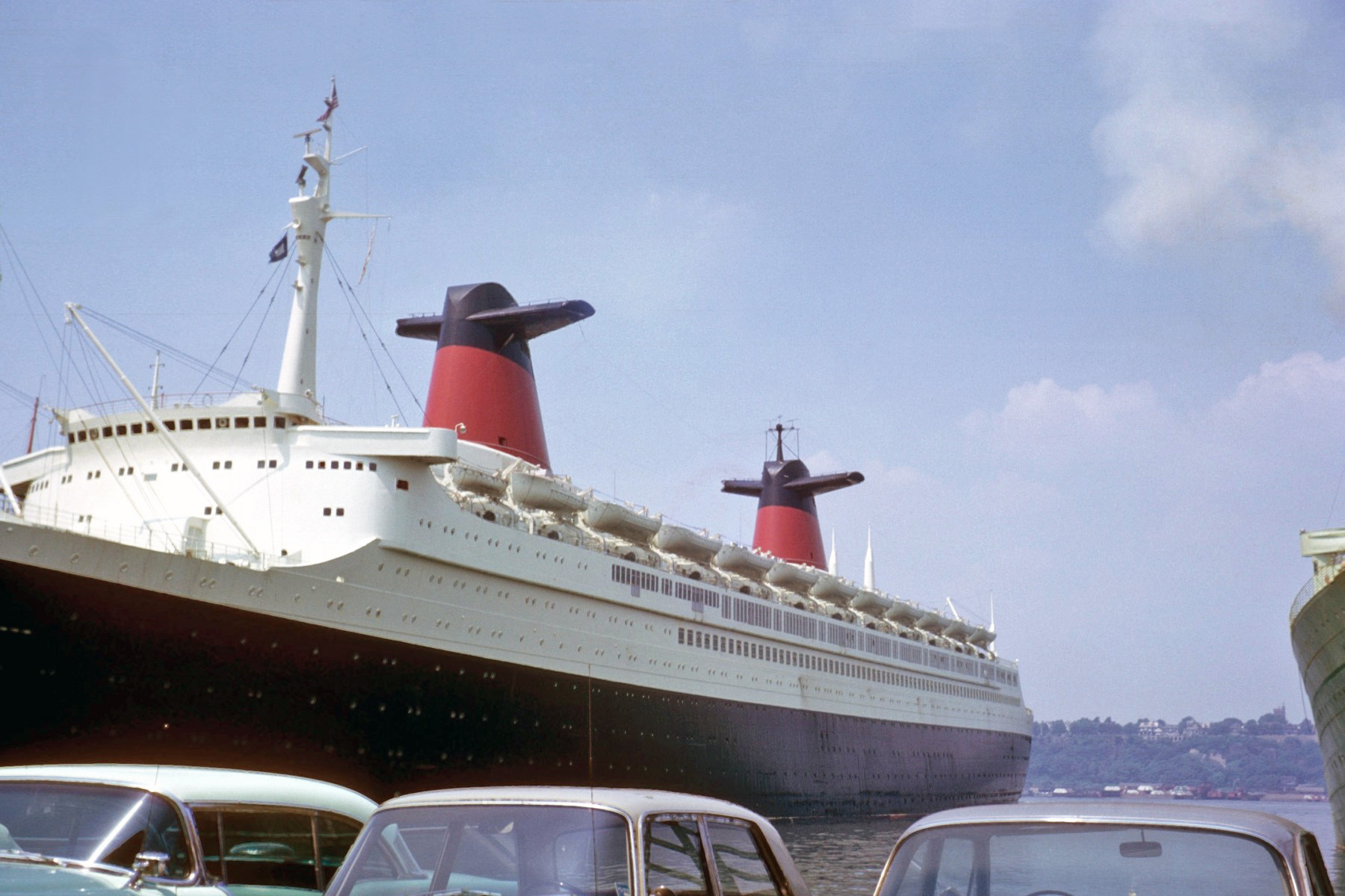 This is a picture of the SS France (French Line) my father took prior to our family boarding the ship at Pier 88, New York for a European trip in the summer of 1963. We were on our way to visit family in both England and France. They don’t build them like that anymore, that includes the cars in the foreground. Gross Tonnage: 66,343; Length: 1,035 ft; Beam: 110.6 ft. View full size.