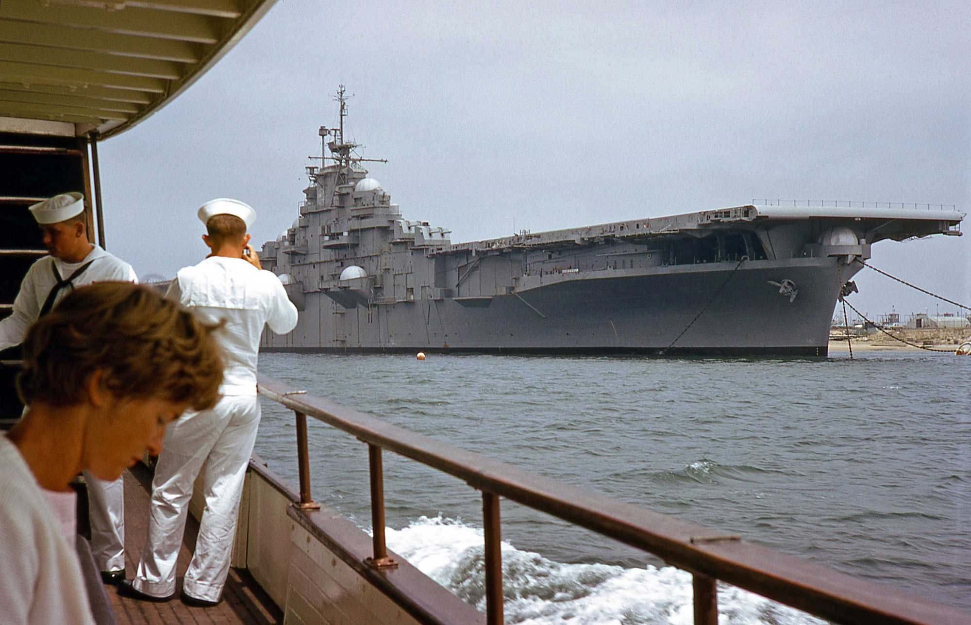 This was taken during the San Diego Harbor cruise in July, 1966. Can anyone identify the carrier? It's got those big deck guns, which makes me think it's World War II vintage. Photo by my dad. View full size.