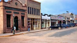 Evaristo Gallegos' O.K. Store was "opposite the courthouse," so this is Fourth Street in Santa Rosa, New Mexico. Though this Kodachrome slide was undated, others in the set had handwritten dates in the mid-1940s. View full size.
Date UncertainThe two 'modern' cars are a 1941 GM product (Pontiac, I think) and a Ford that could be anything from a '41 to a '48.
It&#039;s still therehttps://goo.gl/maps/j1pMNnvc2cD2
and still owned by the Gallegos family.
http://www.manta.com/c/mmfx2p9/o-k-clothiers
car ID Black car with cream wheels:1934/1935 Chevrolet standard coach.
Red replacement wheelI surprised that even the "new cars" look old and scruffy.
Obligatory Auto IDLeft to right: 1934/35 Chevrolet 2dr sedan, 1941 Pontiac coupe, 1936 Cadillac (or maybe LaSalle) 4dr sedan, 194? Ford sedan, 1939 Chevrolet 2dr sedan.
(ShorpyBlog, Member Gallery)