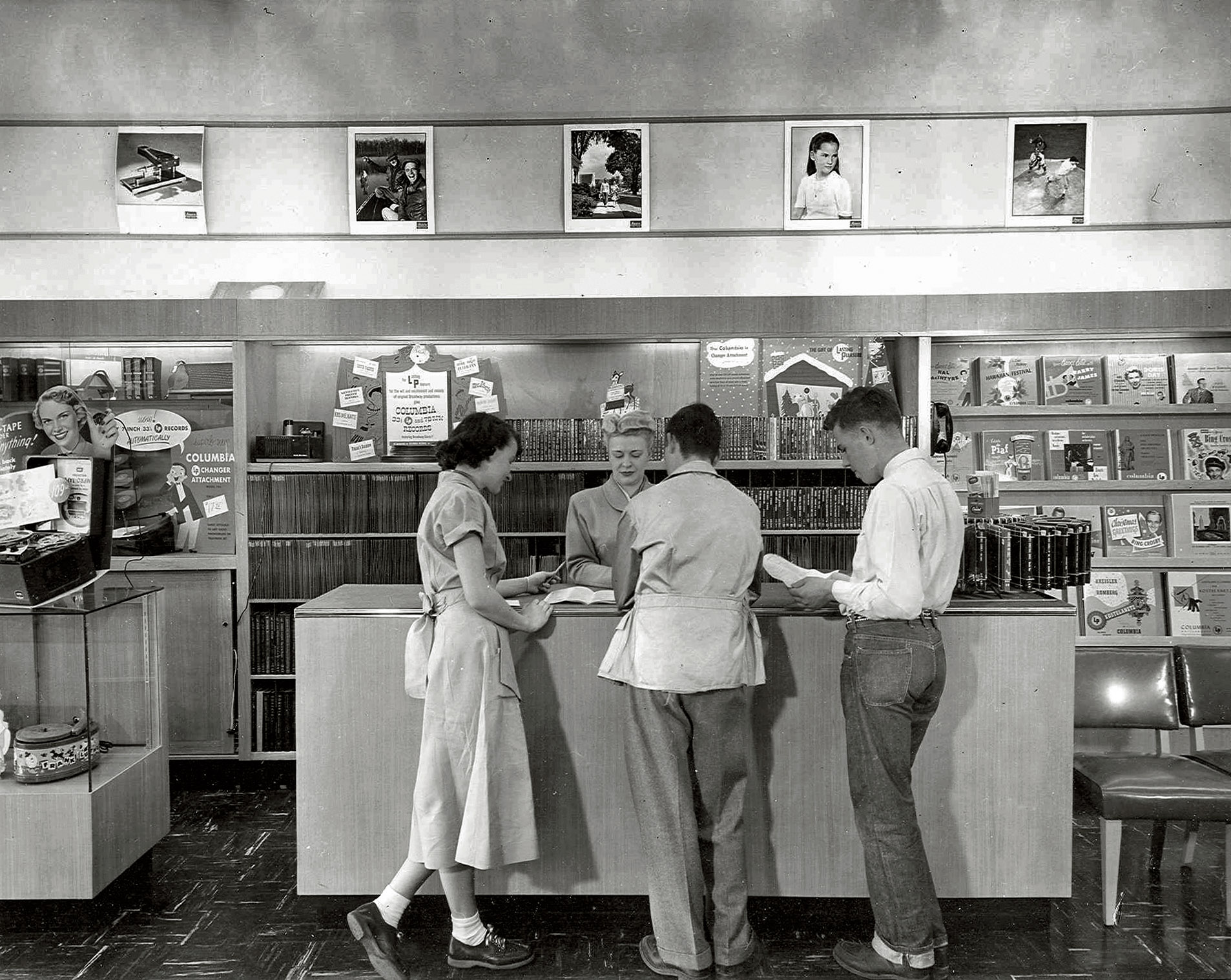 Interior of the Holiday Shop record and camera store at the Roeland Park Shopping Center in Roeland Park, Kansas. View full size. [A fascinating member-submitted photo. Just the thing for a Saturday night. Like a number of the commenters below, I would place the date here around 1950-51. - Dave]