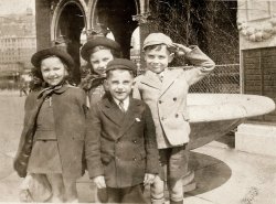My mom and her sister on an outing to the Brooklyn Aquarium.  They lived in Brooklyn Heights and my grandfather would take them on outings on Sundays. Here they are pictured with two boys from the neighborhood. The boy who is saluting...His mom used to watch my mother and aunt while my grandmother worked. View full size.
Aye aye sir....But ....the New York Aquarium to my knowledge moved to Brooklyn from Battery Park  located in Manhattan in , 1957.  That probably explains the taller than typical Brooklyn buildings that would be found in 1938.  Brooklyn Heights is just a hop skip and a jump across the East River to Battery Park.
(ShorpyBlog, Member Gallery)
