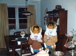 My brother and me in our "Spaceman Spiff"y space helmets, Christmas 1970. View full size.
Dining Room LampI think every household in the 1960s must have had a dining room lamp like that one. They typically had a retractable length of wire contained in a sheet metal ball (visible in the shadow of flash on the wall) that would allow you to pull the lamp all the way down to the table or most of the way up to the ceiling.
Space Odyssey?I think the Spaceman Spiff was in jest(?).  So I wondered what the inspiration for them actually was.  The movie 2001 was two years past in 1970 so that's not likely.
They seem NASA-ish in styling, so maybe they were inspired by the moon walk just a year before.
Pass the Space Food Sticks, I'm hungry!
(ShorpyBlog, Member Gallery)