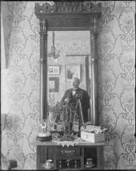 Self-portrait circa 1910. The only thing out of focus is the photographer. Does anyone know what kind of camera he's using? Scanned from the original 5x4 inch glass negative. View full size.