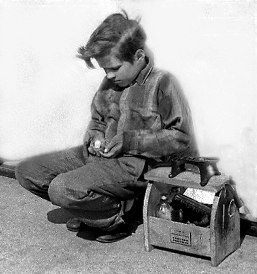 Taken on the boardwalk of Coney Island in 1950. This young boy had been strolling the boardwalk looking for customers. At the end of his day, he sat down to count his earnings. He seemed to be somewhat disappointed.
