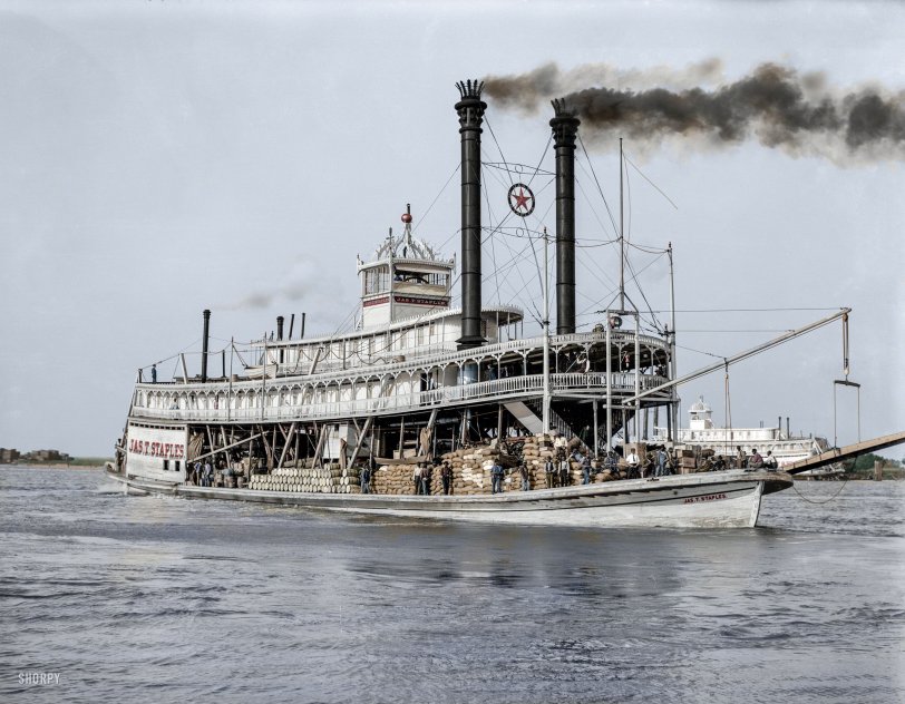 Colorized from this Shorpy original. A comment on the original b&amp;w posting by fellow member Vidiot stated, "That's a strikingly different view of steamboat travel -- actual utilitarian work, transporting freight. Belies the romantic notion of white-suited gentlemen sipping sloe gin. I think I like this view better." I do agree, although to me, there is a gent seated on the second deck above the bow that does fulfill that romantic notion of a riverboat gambler. I can easily imagine that he would not have been a stranger to a deck of cards! View full size.
