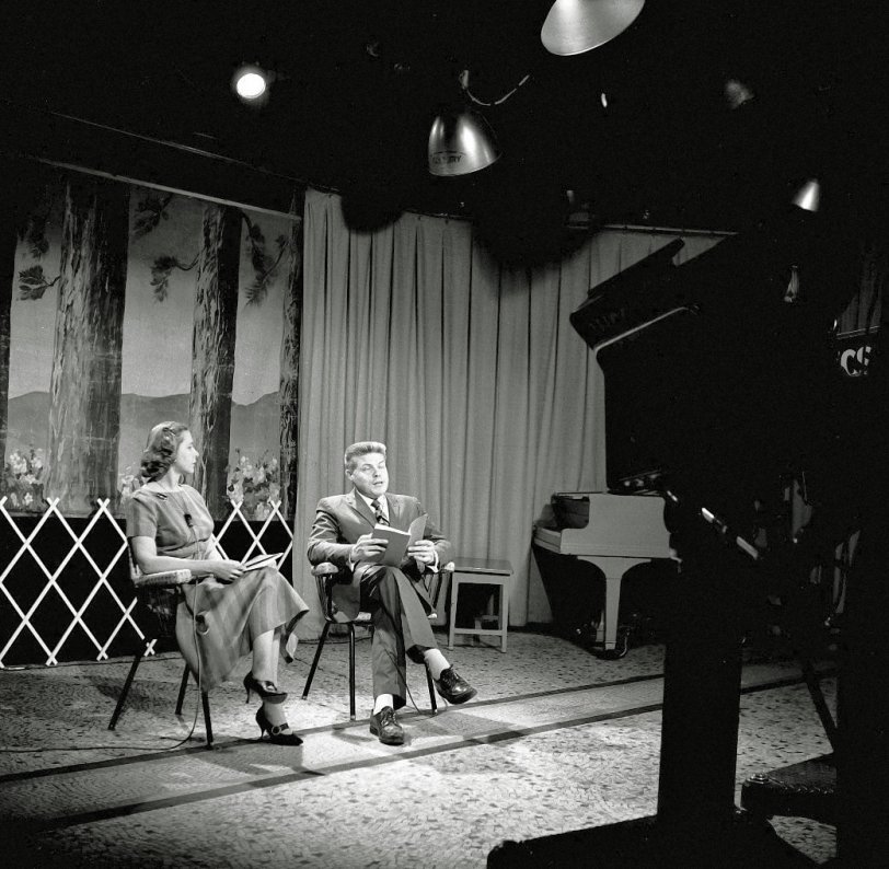Another Maine couple hoping to get famous on TV via WCSH studio in Portland. Not sure if it's a poetry session, story time or some religious sermon. From my negatives collection. View full size.
