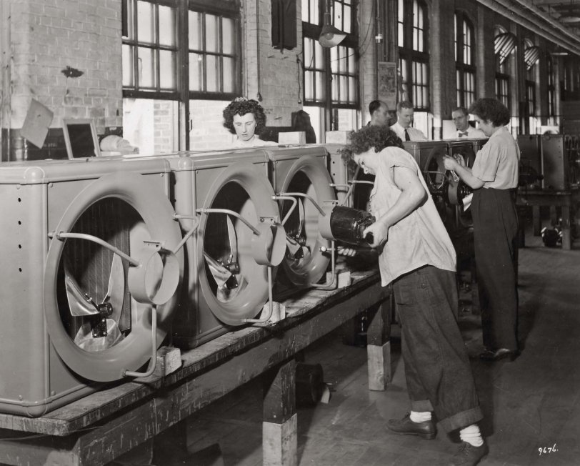 Hyde Park, Massachusetts, 1945. Women assemble speed heaters at the Sturtevant factory (Building C) during WWII. The woman in the foreground is mounting a motor in the heater inlet.
