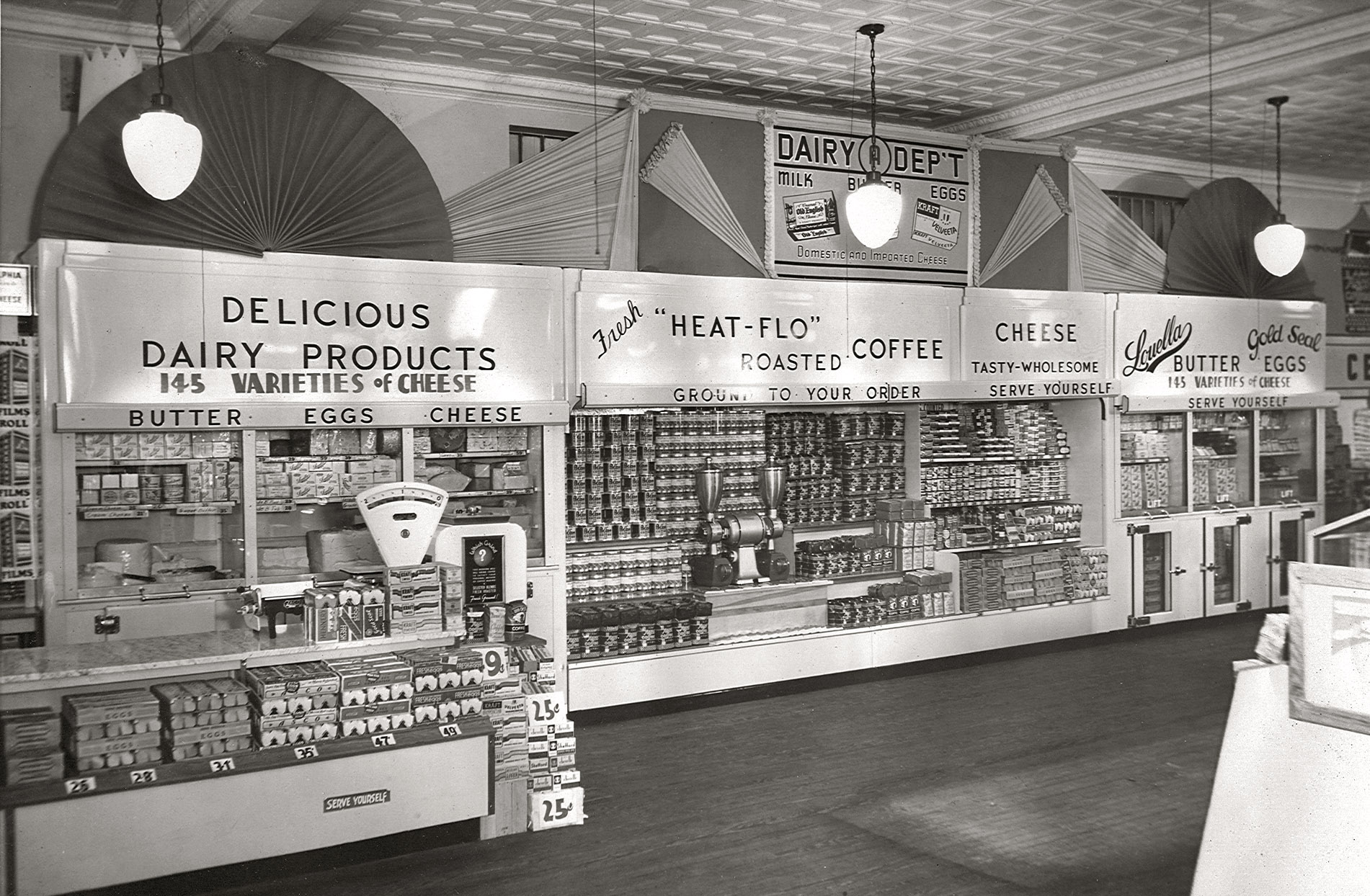 Supermarket dairy case circa 1950. You'll get change back from your half-dollar if you purchase a dozen eggs. View full size.