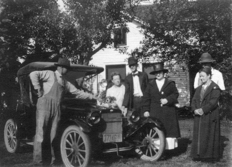 Northern Indiana between 1920 and 1922.  The tall thin man in the middle is my grandfather, Roy Swank.  We're trying to figure out what kind of car this is.  My mom looked online for historical plates in Indiana and decided the license plate is from 1920.
people (left to right) are Jacob Brumbaugh, Kate Schwab Brumbaugh, Roy Swank, Helen Welch Swank (Roy's first wife) Elizabeth Schwab Swank (and sister to Kate). Perhaps behind Elizabeth is Paul Price, who would be Jacob and Kate's son-in-law.
Can anyone tell us what kind of car that is? View full size.
