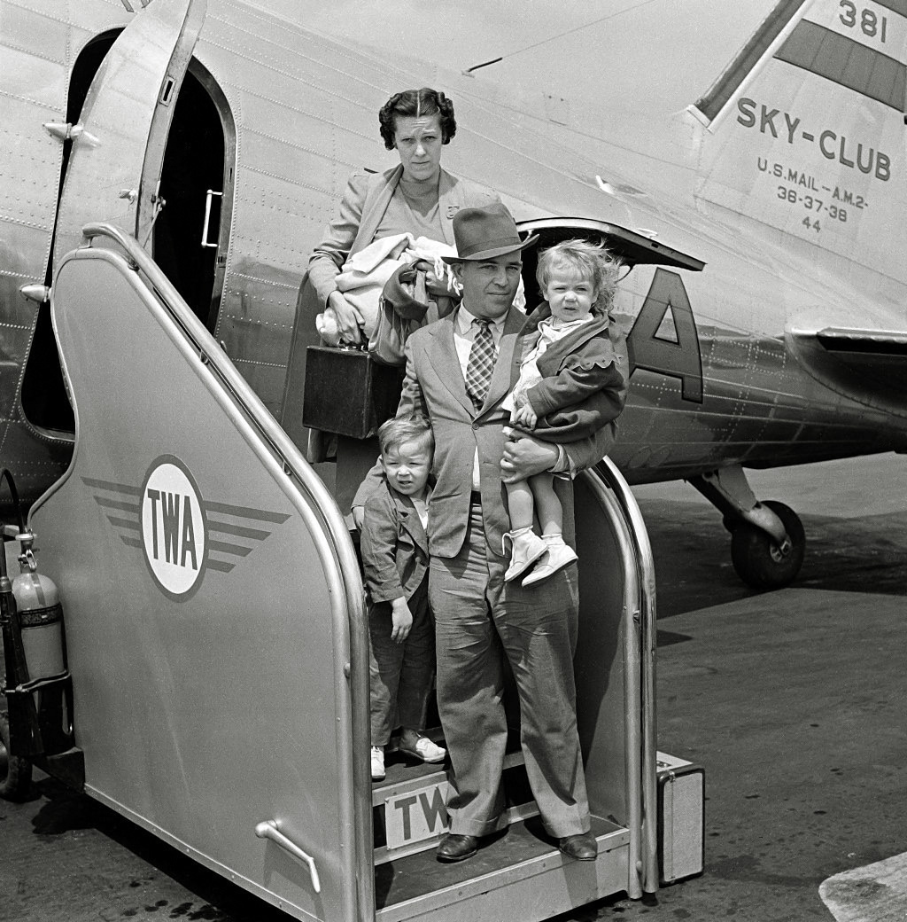 An unidentified family just arriving at the airport on a Transcontinental & Western Airlines "Sky-Club" flight. From my collection of negatives. View full size.