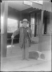 Scanned from the original 5x7 inch glass negative. View full size.
The smallest sheriff.Elevation 6619 feet, but the sheriff appears even shorter than Mr. Hackney. Yet he looks like nothing would scare him as long as he clung to his pipe.
Ray B.
(ShorpyBlog, Member Gallery)