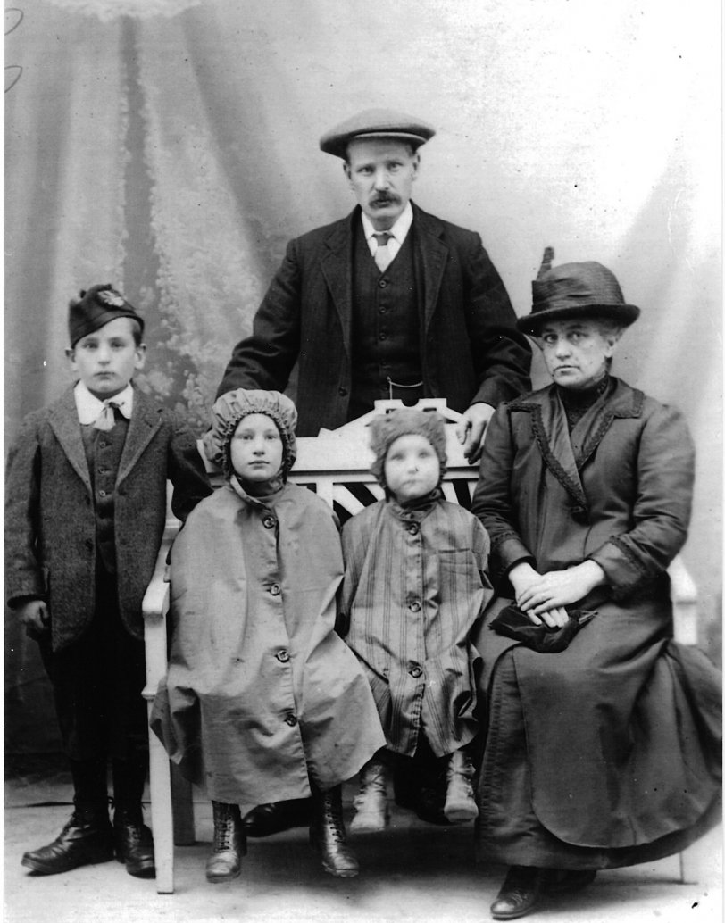 My grandparents Thomas McKinlay Stoddart and Elizabeth Stoddart (nee Hughes) with 3 of their large brood of children. They are both buried in the cemetery at Newton Church (Midlothian, Scotland). At left, I think, is William (b. 1907, d. 1924), middle is Martha "Mattie" (b. 1911, d. 1959), left is Jennifer "Jenny" (b. ?, d. early 1960s). It looks like they were expecting rain. View full size.

