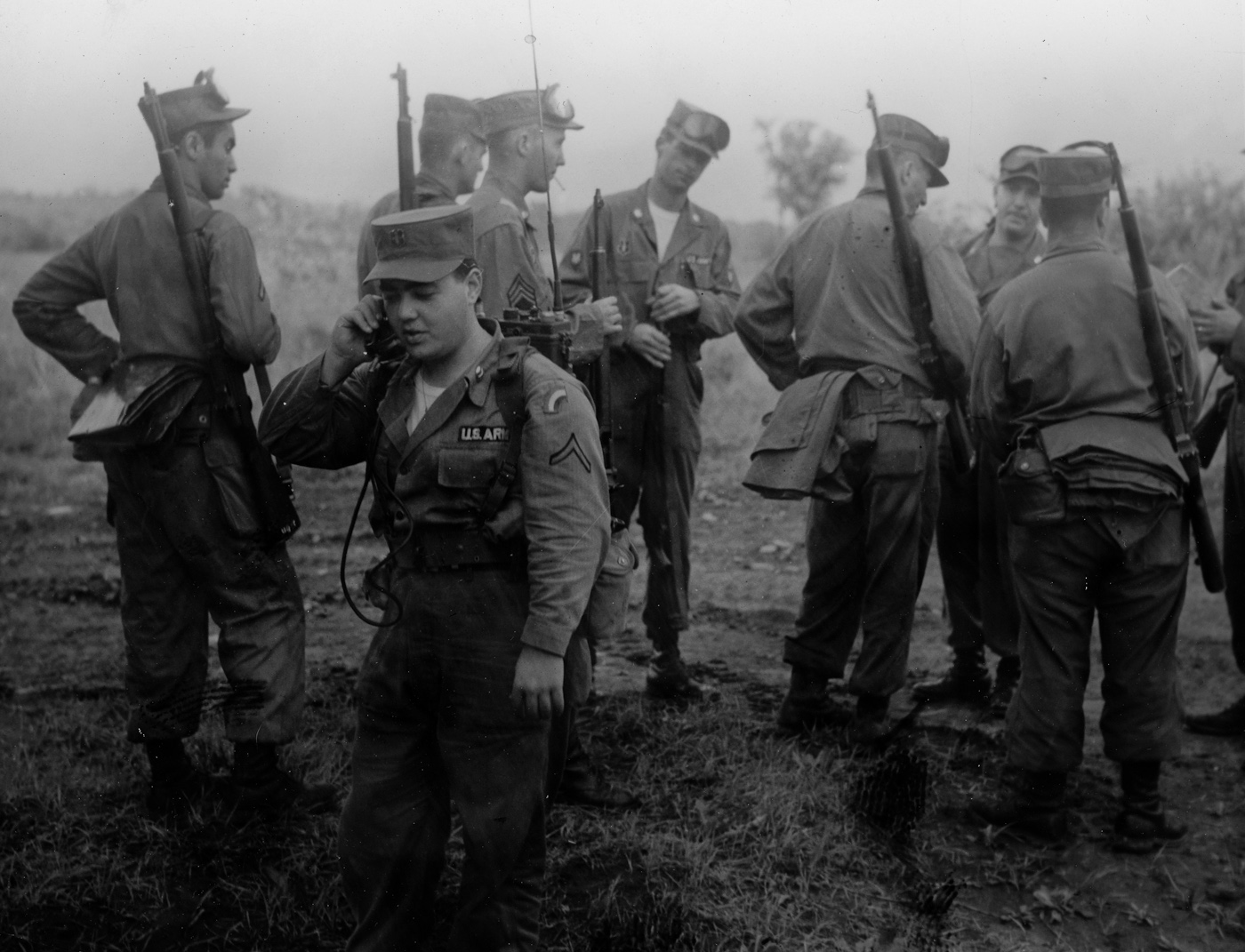 This is the I&R Platoon, 71st Regiment, 42nd Infantry Division, New York National Guard at Fort Drum in 1954 serving as the enemy for maneuver training. Donald McKenna is the soldier in the center of the picture. View full size.