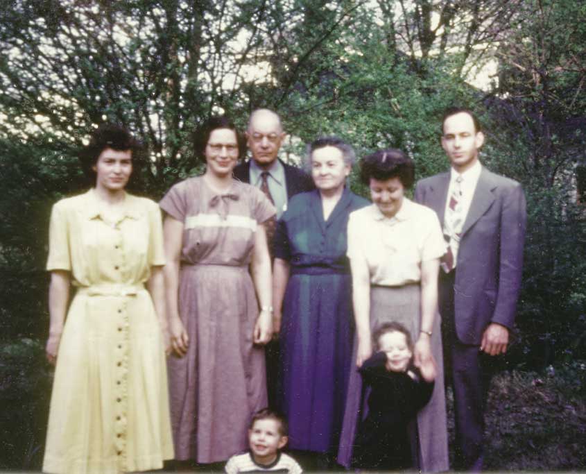 The Tyler kids about twenty years later... Marjorie (Tyler) Craven, Harriet (Tyler) Miller, their father, F. Harold Tyler, their mother, Florence (Carpenter) Tyler, Ruby (Carriker) Tyler, and her husband, Albert Tyler.

Those little guys in the front? That's me, staring into space, and my cousin Mike Tyler, shrugging off his mom's hands.

Steve Miller
Someplace near the crossroads of America