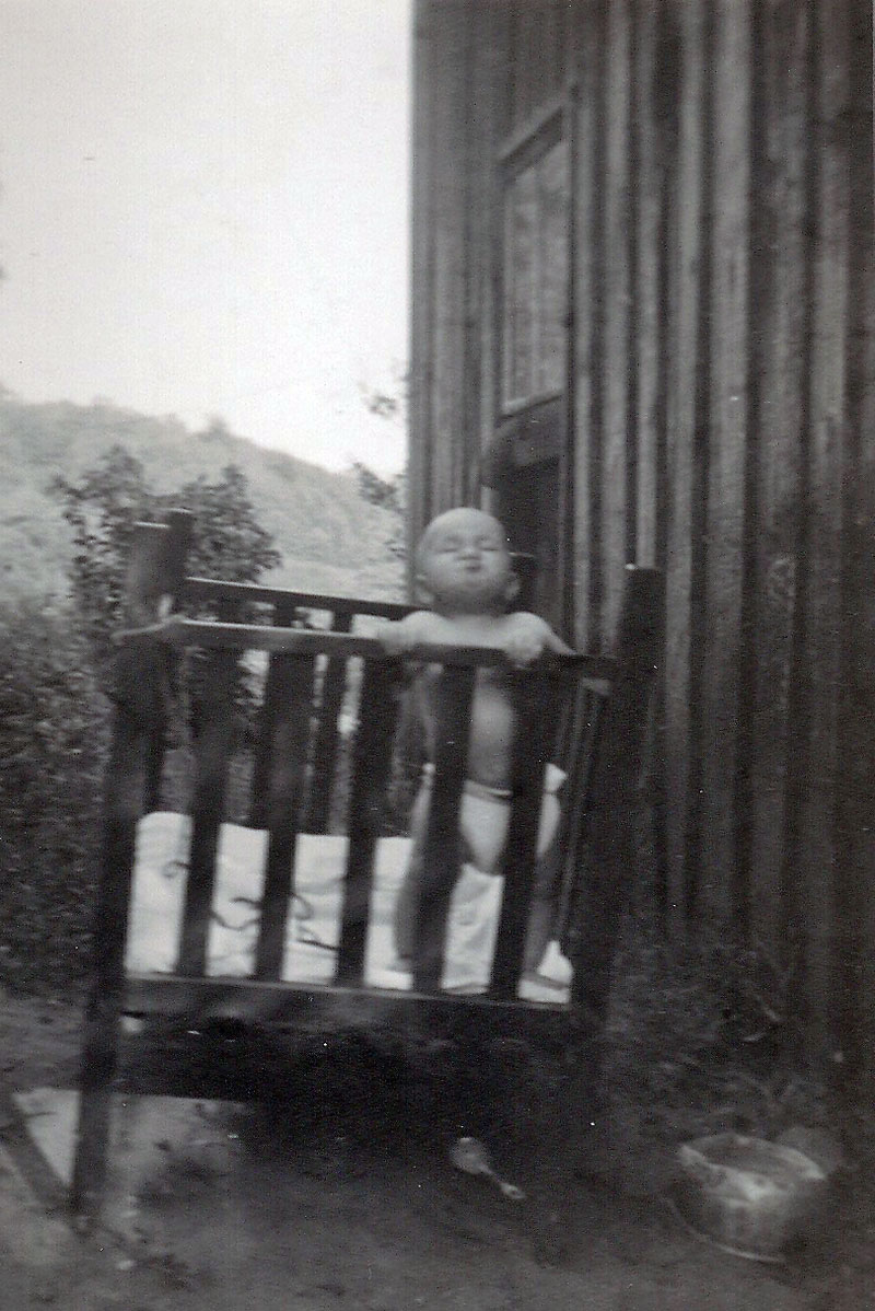 Uncle Richard tied to a post in his crib. Taken in Franklin NC, November 11 1952. View full size.