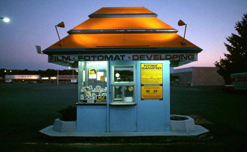 Bedford, Massachusetts, circa 1978. The end is near for this kiosk and many like them across the country. After the demise it turned into a video rental store; now it is gone. It was in the Bedford Plaza. All gone now. Taken on Ektachrome 35mm film. View full size.
