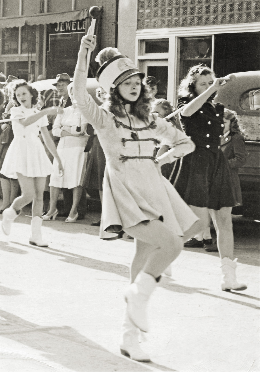 This is my mom, DottieJean Holien, as Drum Majorette leading the Harvey, North Dakota High School Band for the May 8, 1945 V-E Day celebratory parade. View full size.