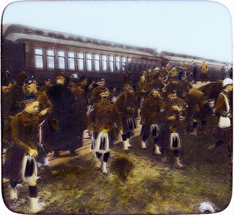 From a WWI hand colored lantern slide by Underwood and Underwood of New York.  Shows the Highlanders arriving at the Valcartier Camp, Quebec.  Circa 1914.
