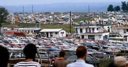 This is part of the parking paddock at Watkins Glen on CanAm weekend, 1970. Lots of American and British/European classics, all collectible today. In the background is the in-field weekend camping area, much of it tents and pickup camper caps then. Was it Watkins Glen or Mosport that the infield was known as "The Swamp" for it's "spirited" nighttime fun? View full size.
Poor Quality PlumbingIn just ten short years the public restrooms at "the Glen" would all change from functional to decorative.. In an attempt to provide a clean fresh smell, someone had dropped several cases of hockey puck sized mints all over the facilities.   Neatly lettered graffiti on one inside wall proclaimed.. "Don't eat the mints" 
(ShorpyBlog, Member Gallery)