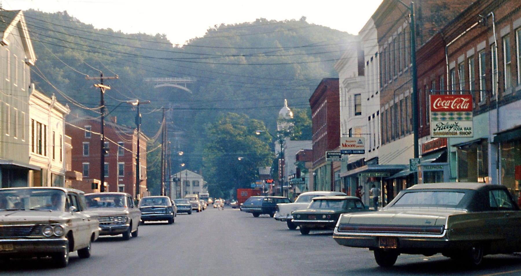Watkins Glen, N.Y. main street, summer 1970, CanAm weekend. I hope the view looks much the same today, minus the period cars and shop signs. 

[This is actually the village of Montour Falls, two miles south of Watkins Glen. - tterrace]

View full size.