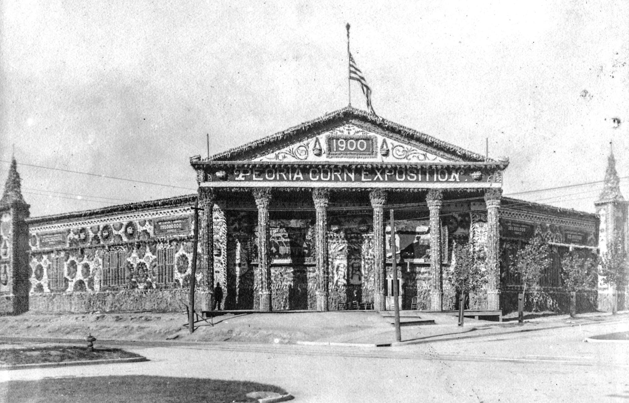 The Peoria Corn Exposition (or Corn Carnival) was a late summer attraction in Peoria from 1898 to 1902 with headquarters in this building on Globe Street between Main & Hamilton Streets. This wooden octagonal building which seated 7,000 was first built as a tabernacle for religious meetings. As the Corn Palace, the entire theme of decoration was corn, both inside and out. The week-long carnival included street shows with music or jugglers at nine different downtown corners, concerts by numerous bands, a governor's day with an industrial parade, bicycle races, a ladies day, husking matches, fireworks displays, premium awards at the Exposition Building and a Grand-Masked Parade and Carnival. The 1900 program lists the official song with music by Prof. Eugene Plowe and words by Peoria poet Edna Dean Proctor. "Blazon Columbia's Emblem, the Bounteous Golden Corn."

Original photos taken by William A. Gregory who lived on North Sheridan in Peoria. William worked for Frank D. Murray, a Peoria contractor (1881-1957) who built 100+ houses, including a good number on Frye Ave. William A. Gregory was an amateur photographer, picking up the hobby early on, taking thousands of architectural and event pictures of Peoria.