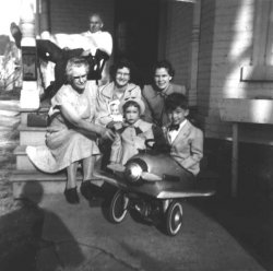Young pilot and his family. Walnut St. Rochester, Michigan, 1954. My grandfather is resting his bad leg, which was injured in a copper mining accident in the Upper Peninsula. Others include my grandmother, mother, aunt, cousin, and father's shadow.
Dressed up for SundayBeautiful family and in '54, all of my family also dressed in their best every Sunday.  My grandfather was a retired coal miner with accident-injured legs also, but he made Sunday his "day of rest" and always wore a white shirt and dress clothes.   We would usually go for a ride and an ice cream cone Sunday afternoon.  Great days.
(ShorpyBlog, Member Gallery)
