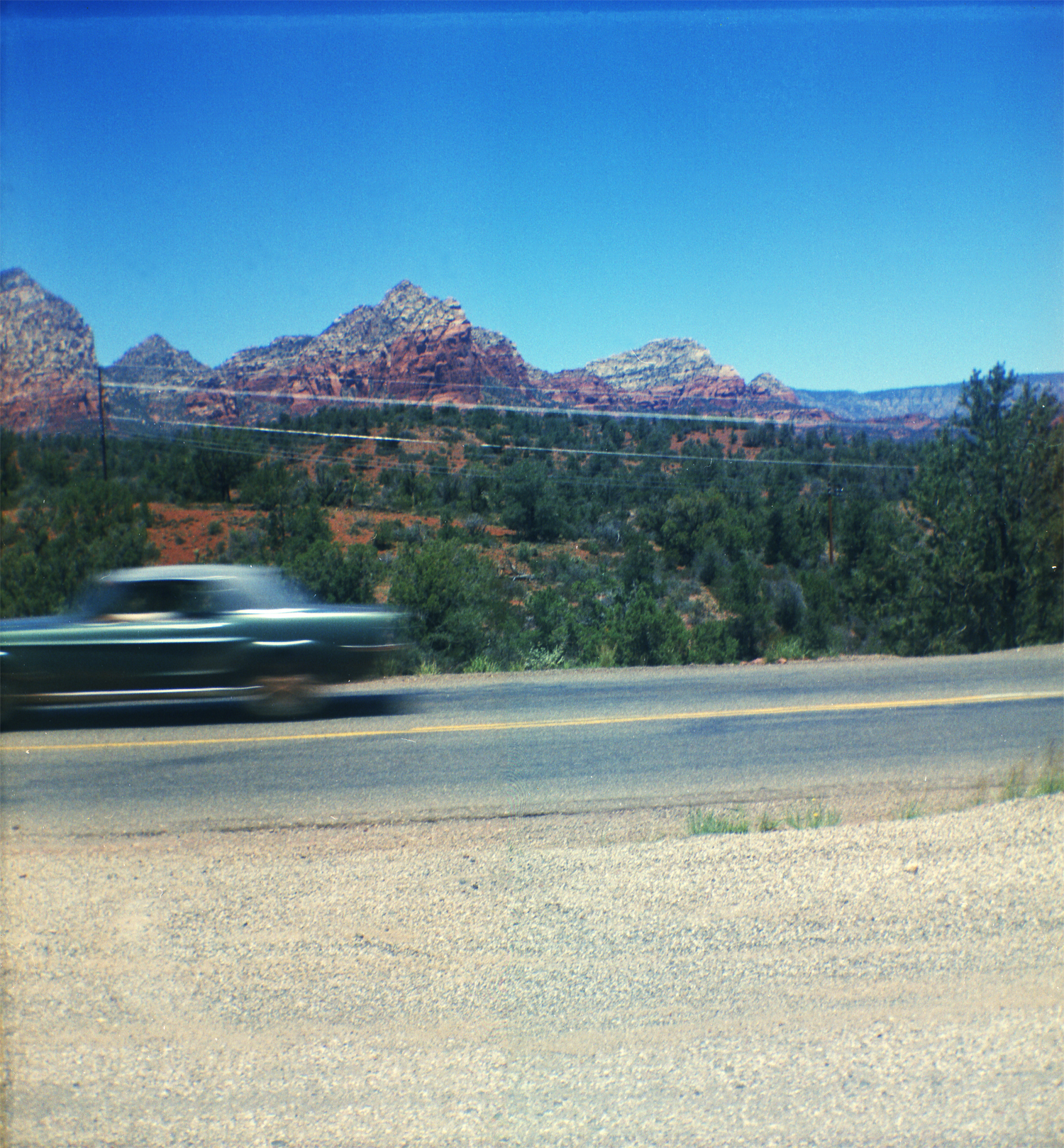 My father and his sister traveled to Illinois from California with my great grandparents for my grandpa's wedding. This was taken on the trip back to Los Angeles through Zion National Park. My dad wishes the camera, a Kodak Brownie, could have caught the car in focus but I think it's cool like it is. View full size.